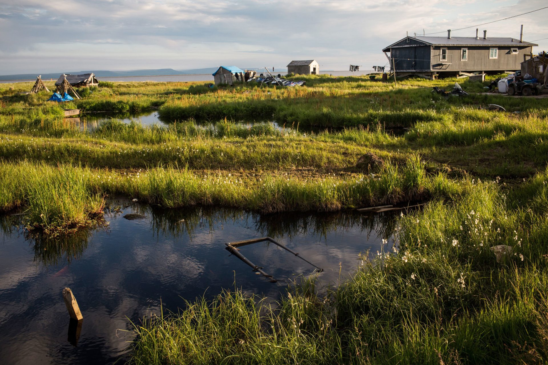 Rising temperatures in Alaska are melting permafrost, widening rivers and eroding homes in the remote village of Newtok, where about a third of residents relocated to higher ground last year.