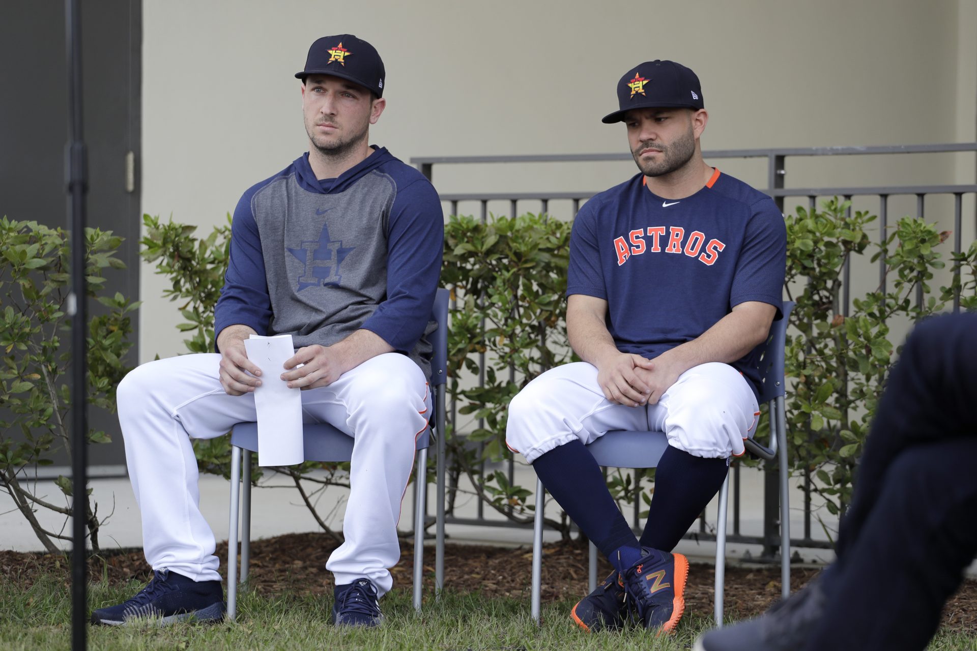 Houston Astros infielder Alex Bregman, left, and teammate Jose Altuve sit in chairs as the wait to deliver statements during a news conference before the start of the first official spring training baseball practice for the team Thursday, Feb. 13, 2020, in West Palm Beach, Fla.