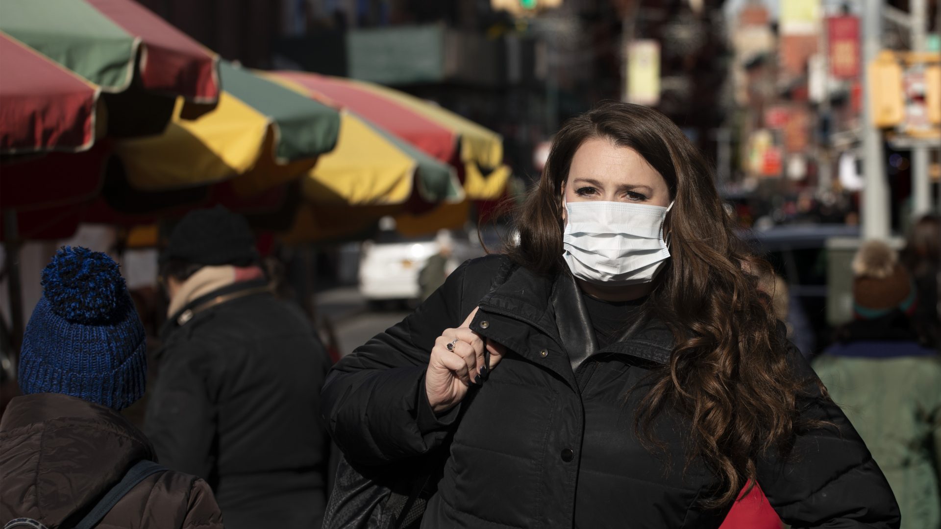 A woman, who declined to give her name, wears a mask in New York out of concern for the newly emerged coronavirus.