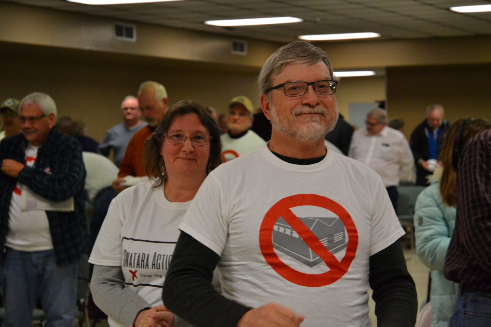 People wearing Swatara Action Team tee shirts celebrate after the township board of commissioners voted unanimously to deny a permit to the developer Monday, Feb. 10, 2020.