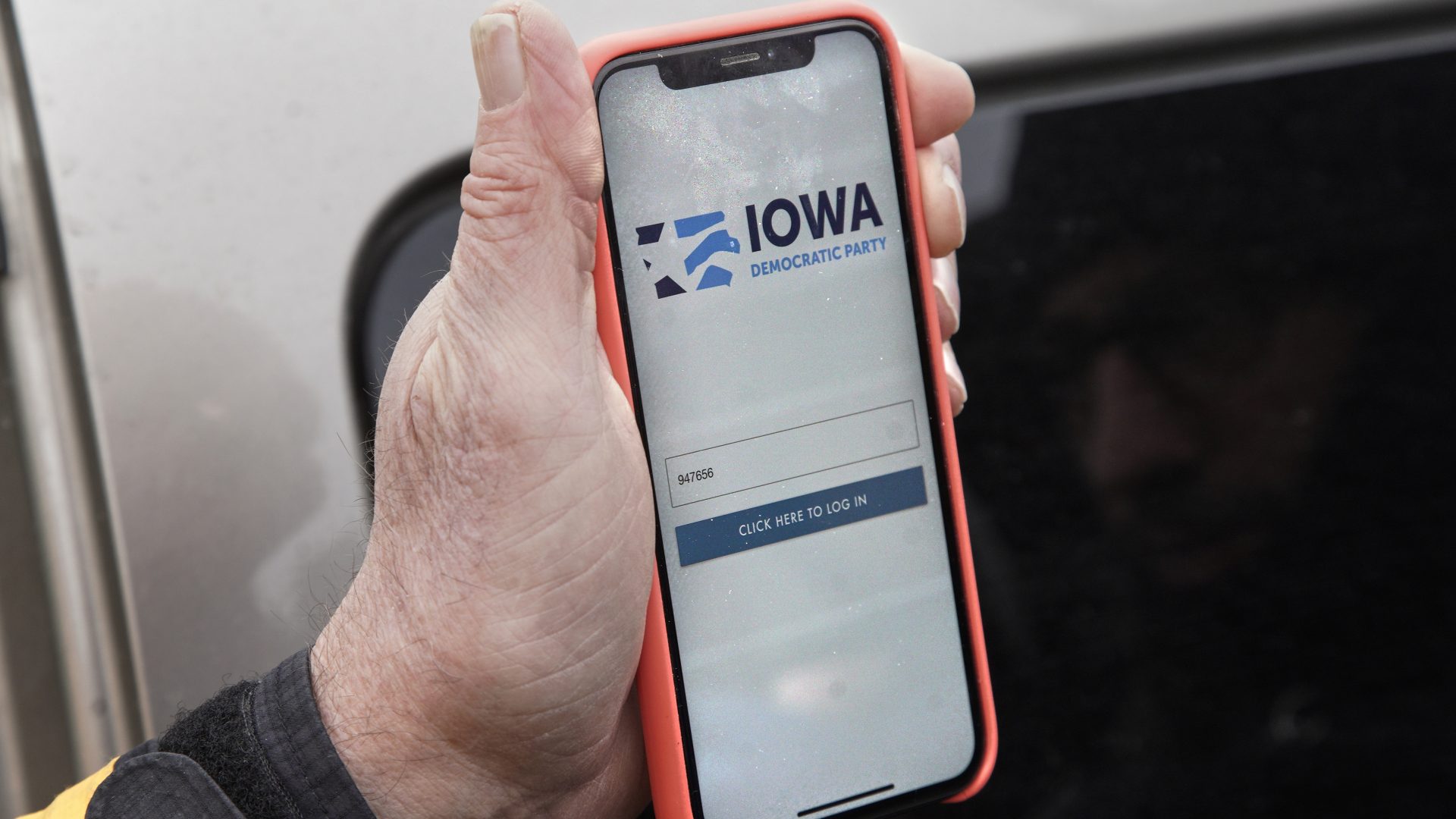 Precinct captain Carl Voss of Des Moines displays the Iowa Democratic Party caucus reporting app on his phone outside of the Iowa Democratic Party headquarters.