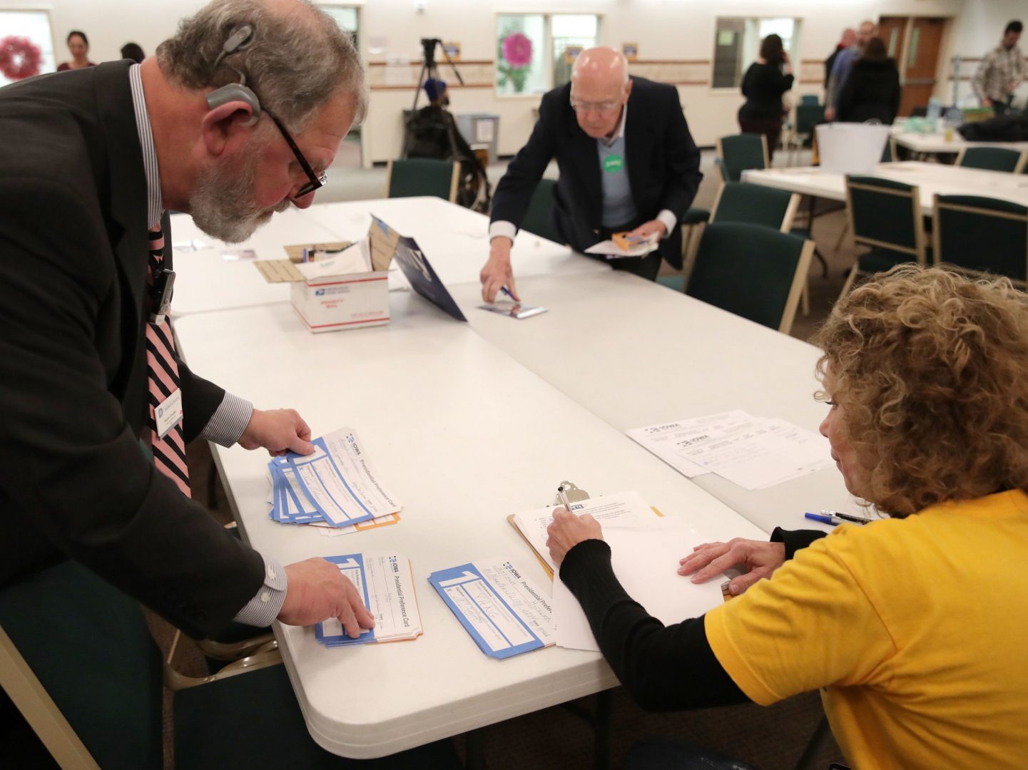 Presidential preference cards are counted at a caucus at West Des Moines Christian Church in Iowa on Monday. Problems with a smartphone app designed to report the caucus results ended up delaying an official count.