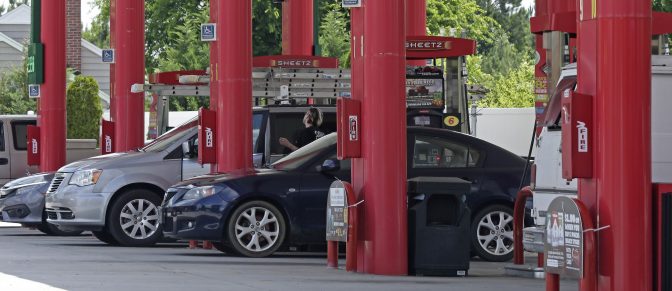 In this photo taken Thursday, June 14, 2018 cars are fueled at Sheetz along the Interstate 85 and 40 corridor near Burlington, N.C.