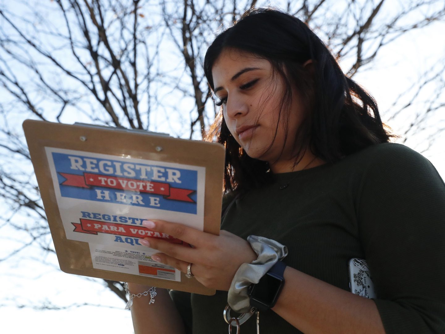 Karina Shumate, 21, a college student, filled out a voter registration form in Richardson, Texas on Jan. 18. One big registration effort this year has drawn controversy among elections officials.
