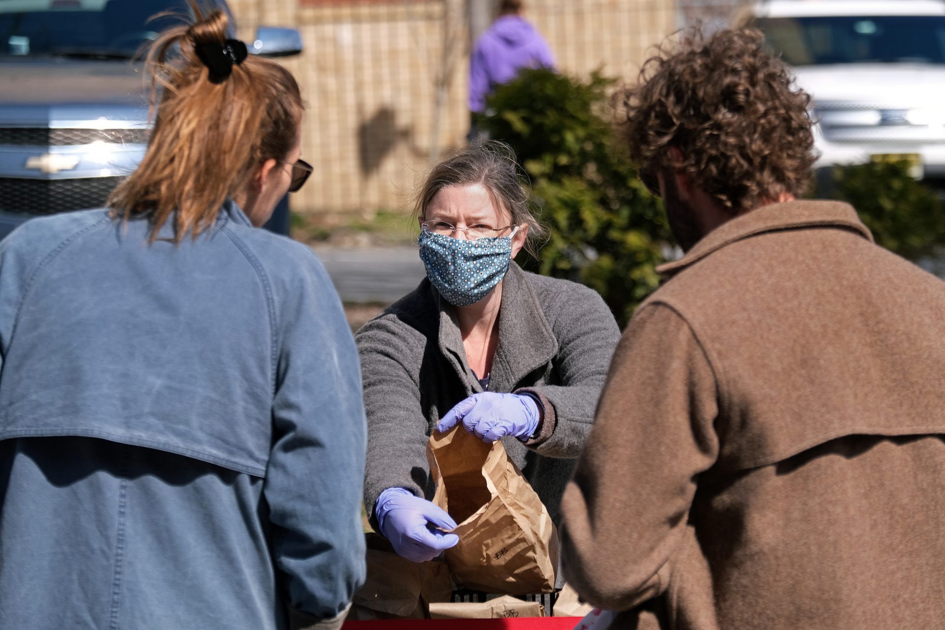 Jesse Tobin, from Primordia Mushroom Farm in Lenharstville, wears gloves and a mask as she sells to customers Mar. 21, 2020, at the Easton Farmers' Market in Easton, Pennsylvania which is the oldest, continuous open-air market in the country. Tobin says most of her family farm's business comes from selling to restaurants and that they've lost 80% of their revenue in just the last two days. Tobin says of being able to still be able to sell at the Easton Farmers' Market: "This has been great to have because it's all we got." Communities across the Lehigh Valley are adjusting to life during the coronavirus pandemic that is impacting the daily lives of Pennsylvania residents both socially and economically.