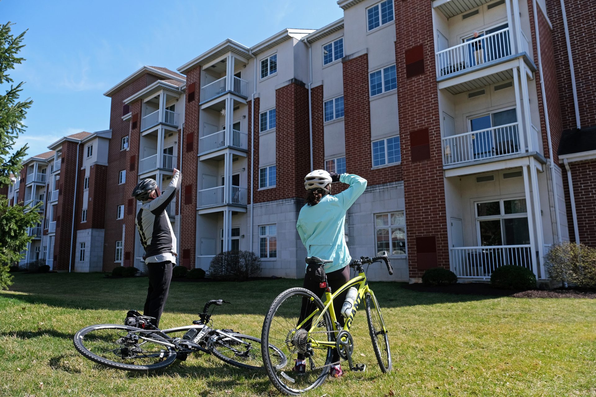 Wayne Achey, left, of Bethlehem, and his wife Karen Achey, right, of Bethlehem, look up as they talk to Wayne's mother Marilyn Achey as she stands at her third-floor balcony Mar. 21, 2020, at the retirement community Moravian Village of Bethlehem in Bethlehem, Pennsylvania.