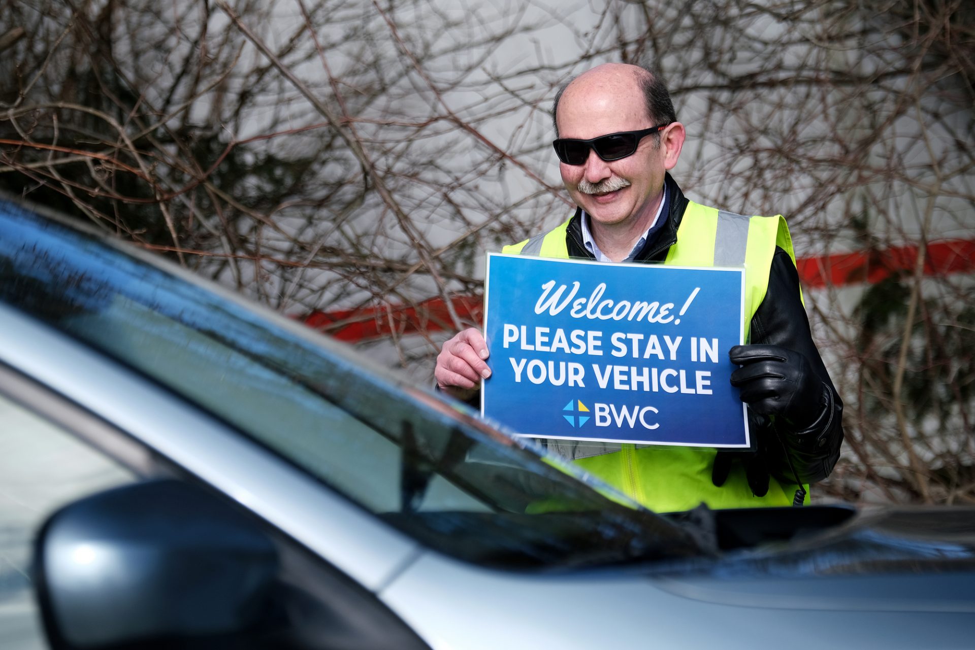 Pastor Dwight Addington holds a sign while parishioners arrive as Bethany Wesleyan Church holds Sunday worship service at Becky’s Drive-In in Northampton County