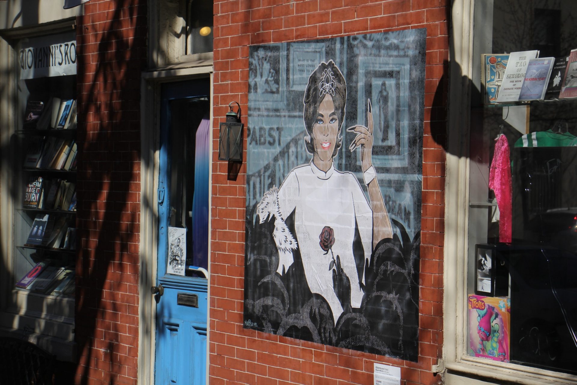 Marisa Velázquez-Rivas's portrait of Nizah Morris is wheat pasted to the wall of the Philly AIDS Thrift @ Giovanni's Room. The transgender entertainer was murdered in 2002.