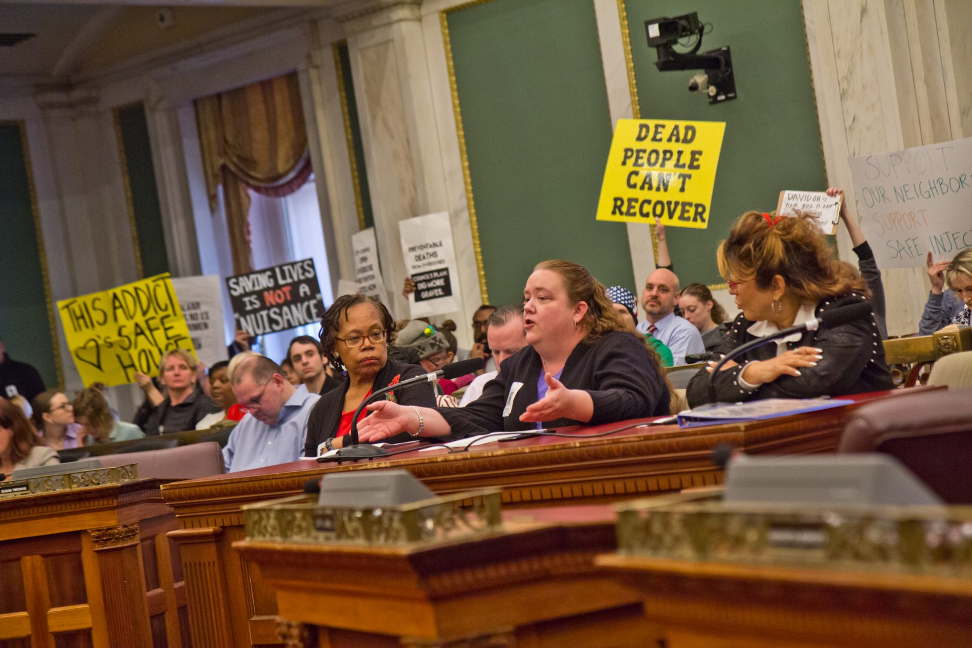 Shannon Farrell, (center) president of the Harrowgate Civic Association, testifies at a hearing on safe injections sites in Philadelphia city council Monday.