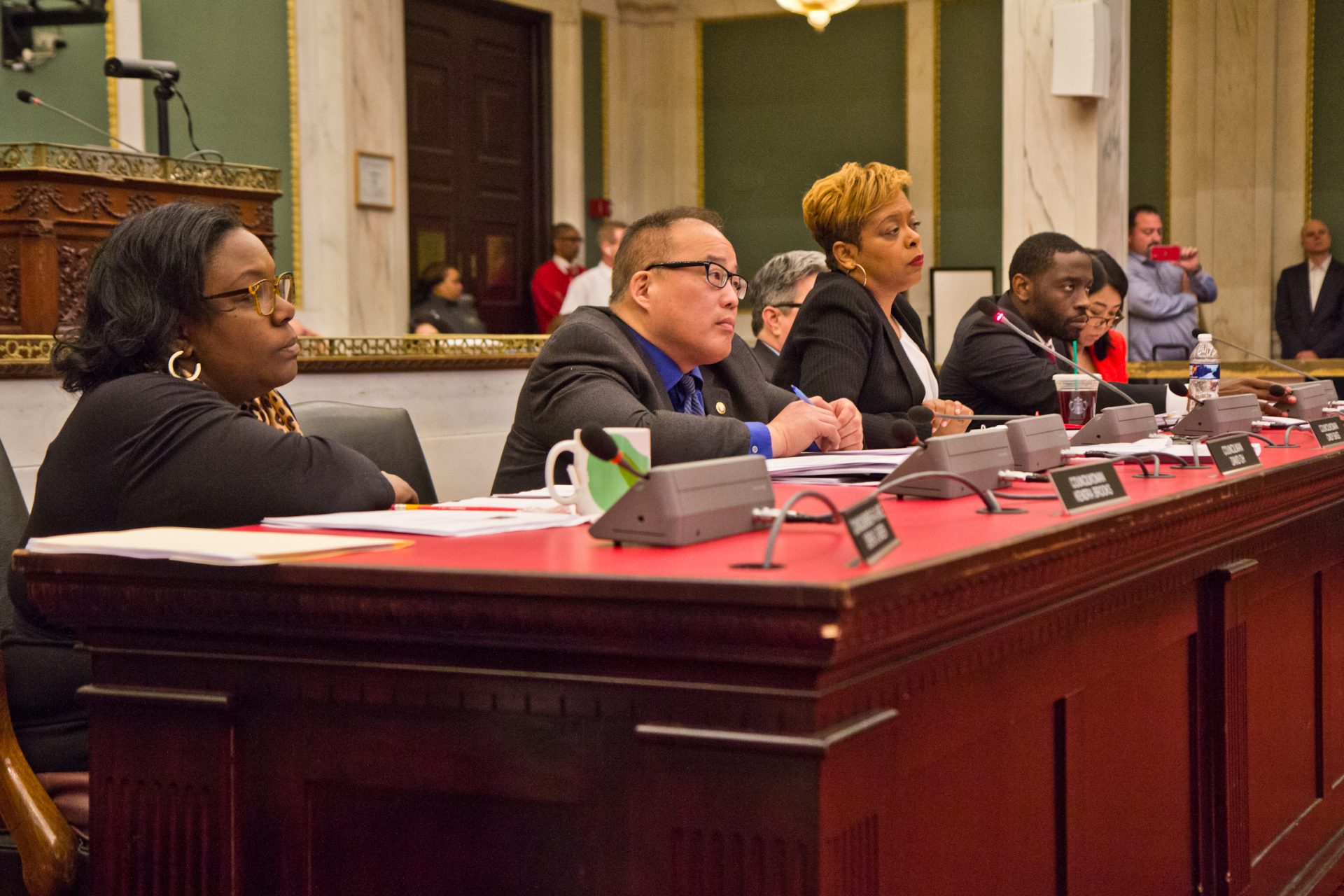 Council person David Oh (second from left) and other council members hear testimony on safe injection sites Monday in city council.