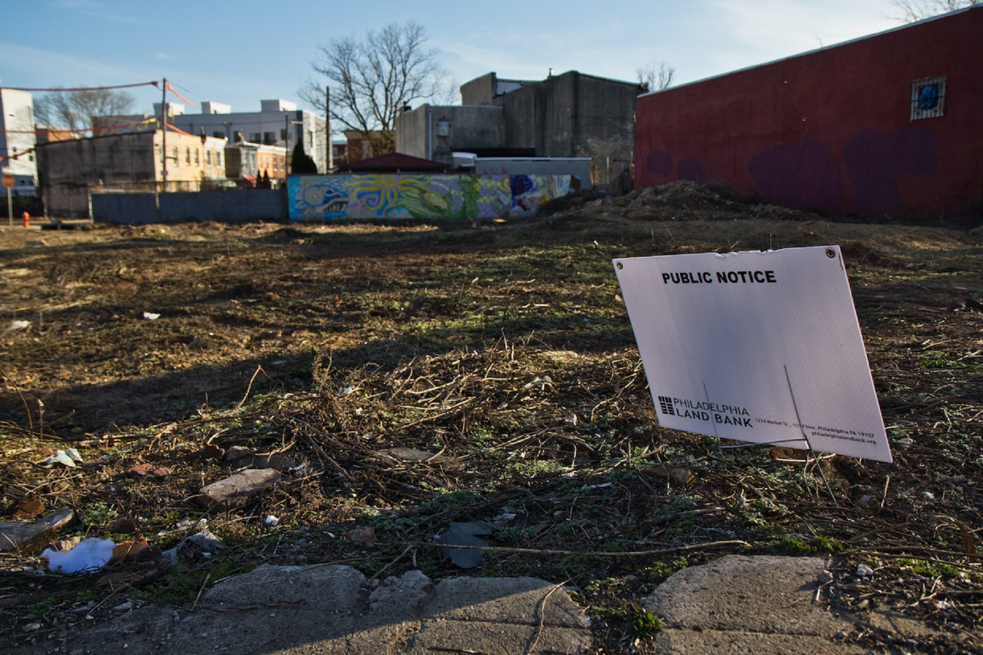 A public notice of sale staked into the lot where the César Andreu Iglesias Community Garden plants corn every year in Kensington.