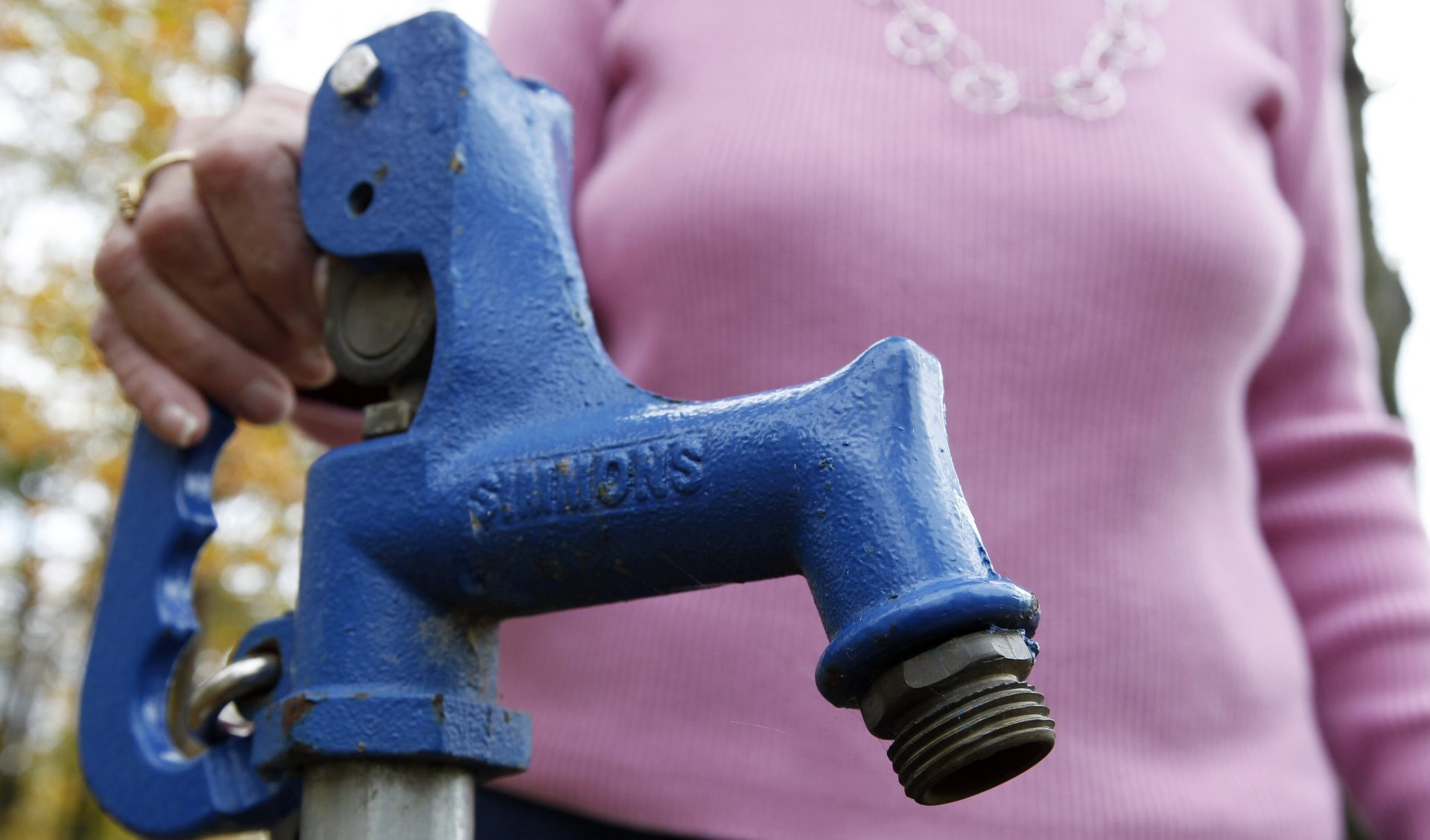 Jean Carter poses for a photograph with the water spigot that is used to test her well water, Friday, Oct. 14, 2011 in Dimock, Pa.