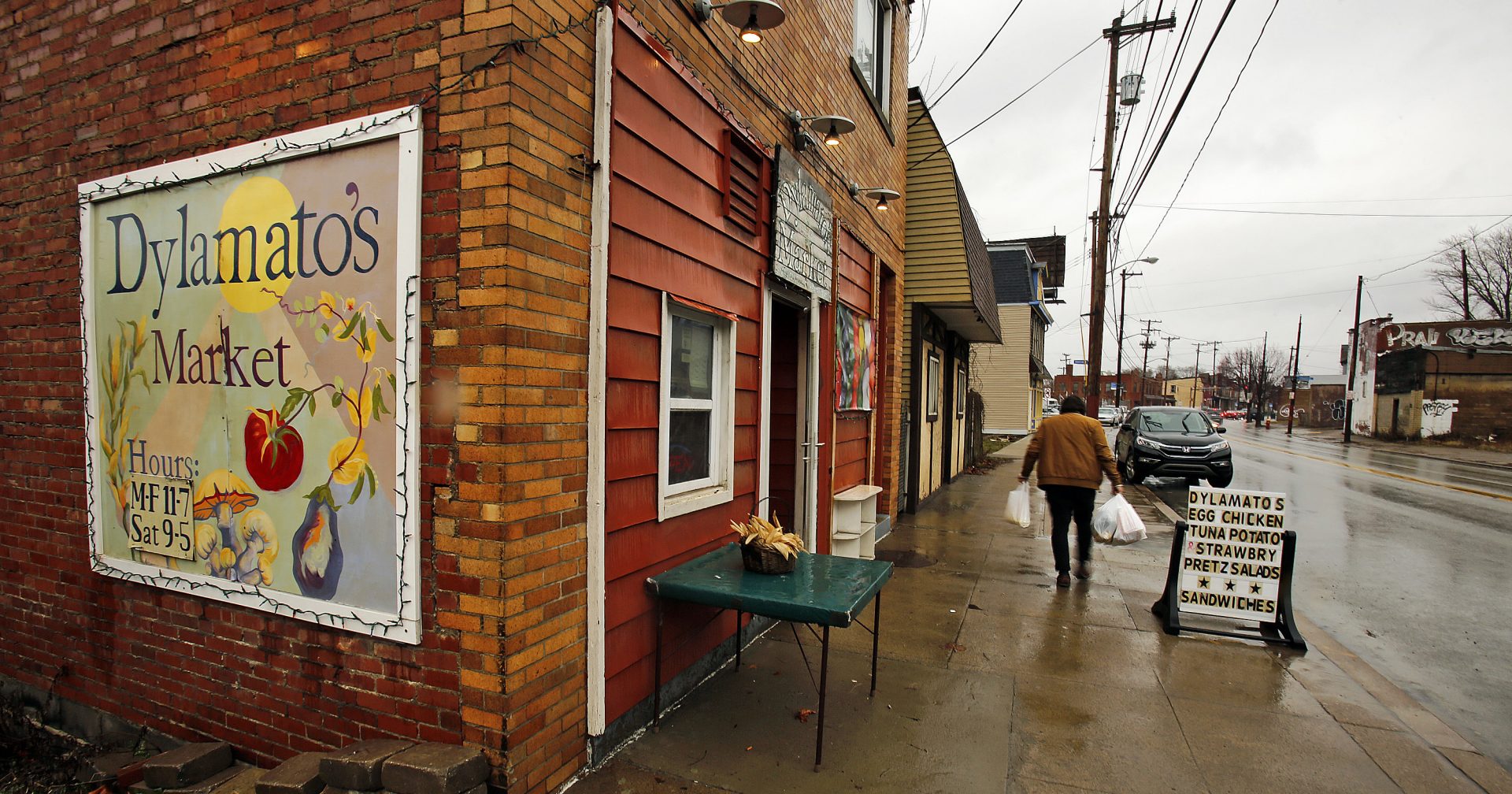 In this March 1, 2018 photo, a customer leaves Dylamatos Market owned by Dianne Shenk in the Hazelwood neighborhood of Pittsburgh. About a quarter of Shenk's customers pay with benefits from the federal Supplemental Nutrition Assistance Program.