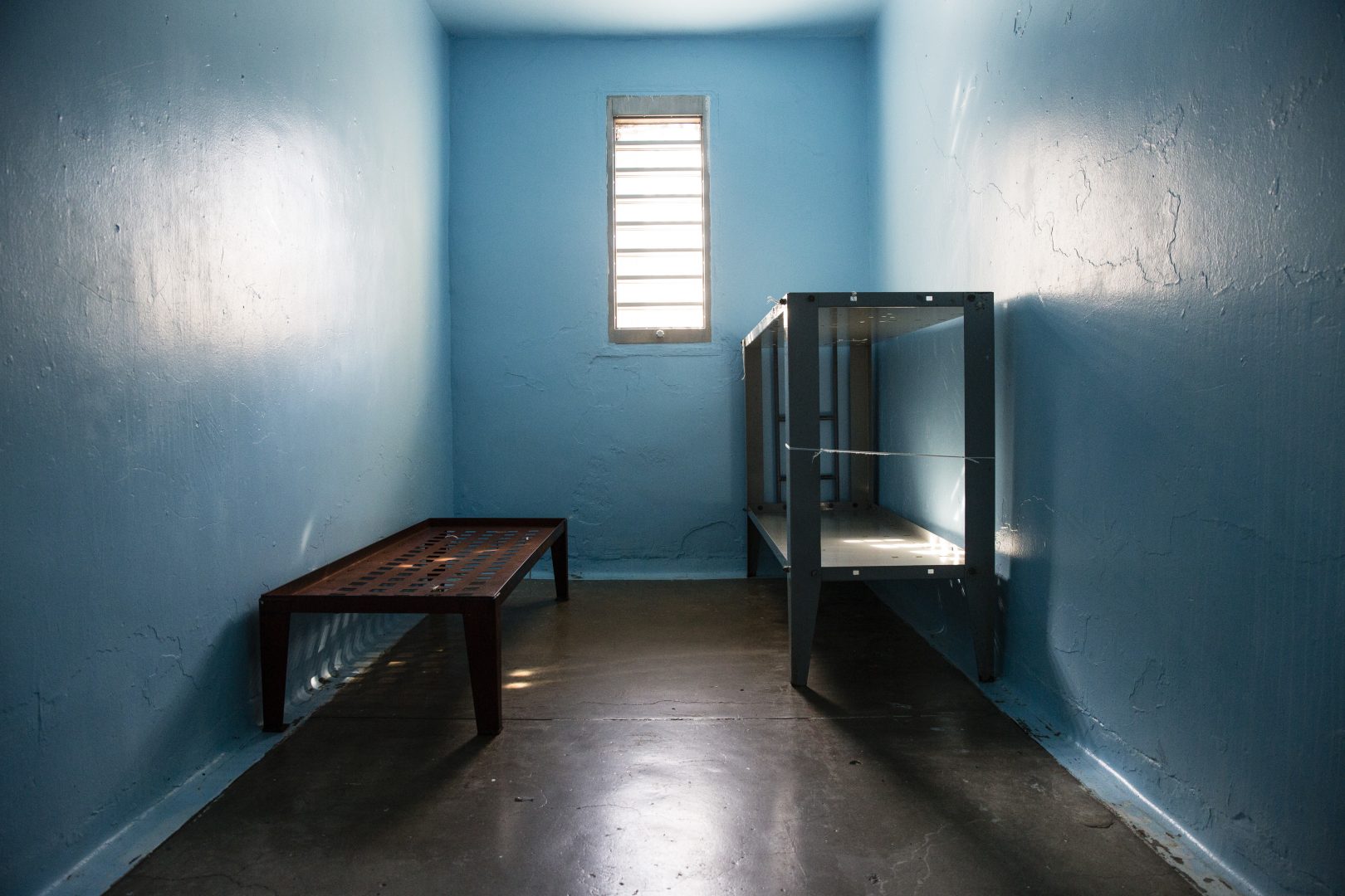 Empty beds in a jail cell.
