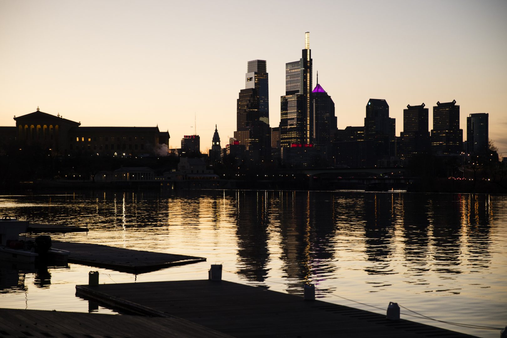 The skyline is reflected in the Schuylkill River as the sun rises over Philadelphia, Thursday, Feb. 14, 2019.