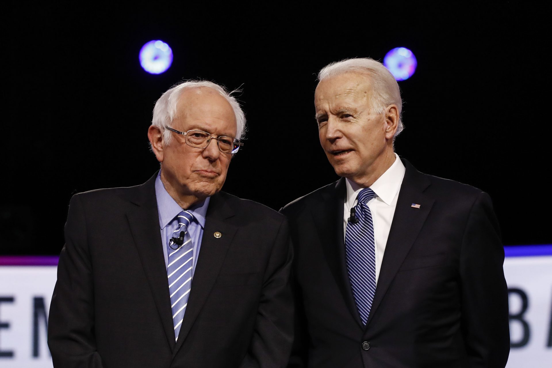 From left, Democratic presidential candidates, Sen. Bernie Sanders, I-Vt., former Vice President Joe Biden, talks before a Democratic presidential primary debate, Tuesday, Feb. 25, 2020, in Charleston, S.C.