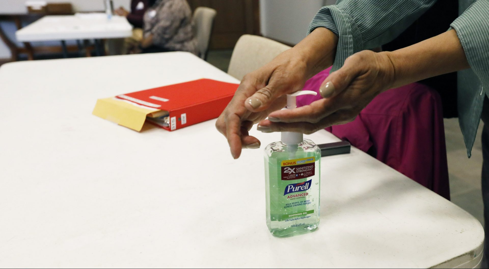 A voter takes advantage of the hand sanitizer to "clean up" after voting in the presidential party primary in Ridgeland, Miss., Tuesday, March 10, 2020. Polling locations are providing hand sanitizers for voters to use as a cautionary measure in light of the coronavirus health concern nationwide.