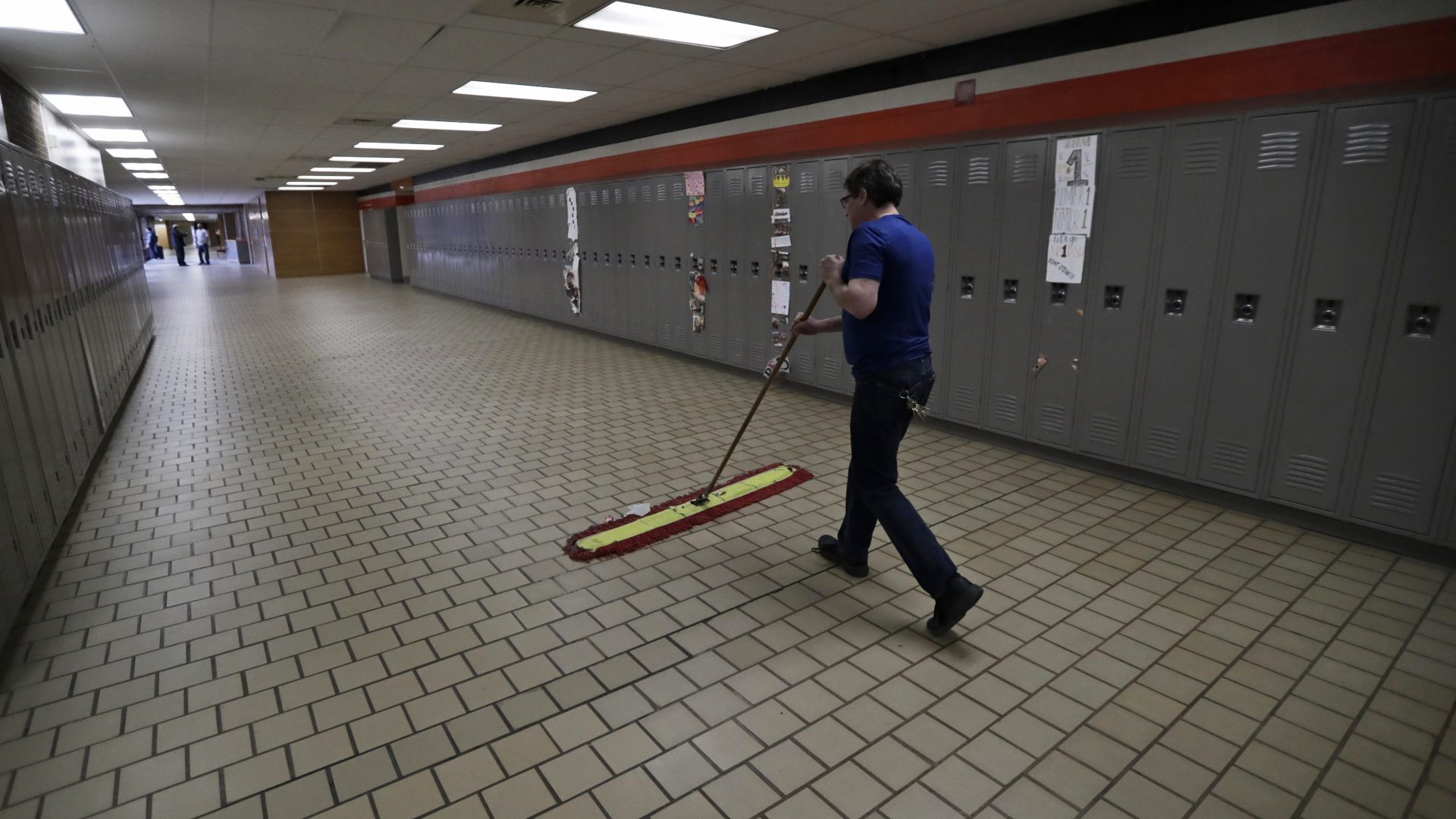 Evening building supervisor Randy Allen sweeps the hallways at Orange High School, March 12, 2020, in Pepper Pike, Ohio. Gov. Mike DeWine ordered all schools closed for three weeks. Pennsylvania Gov. Tom Wolf on March 13 ordered all K-12 schools in the state be closed for 10 business days, starting Monday.