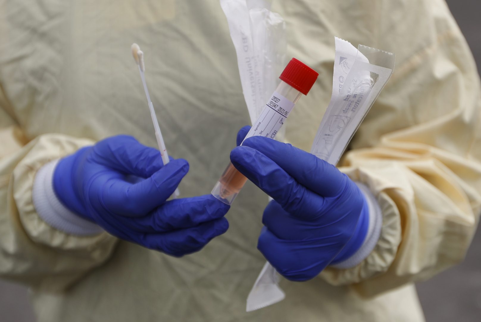 A nurse holds swabs and test tube to test people for COVID-19 at a drive through station set up in the parking lot of the Beaumont Hospital in Royal Oak, Mich., Monday, March 16, 2020.