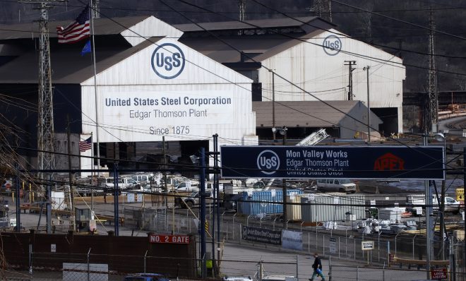 A worker leaves the U.S Steel Edgar Thomson Works in Braddock, Pa., Thursday, March 26, 2020. The plant was exempted from Pennsylvania Gov. Tom Wolf's order on Monday for "non-life sustaining" businesses to close. (AP Photo/Gene J. Puskar)