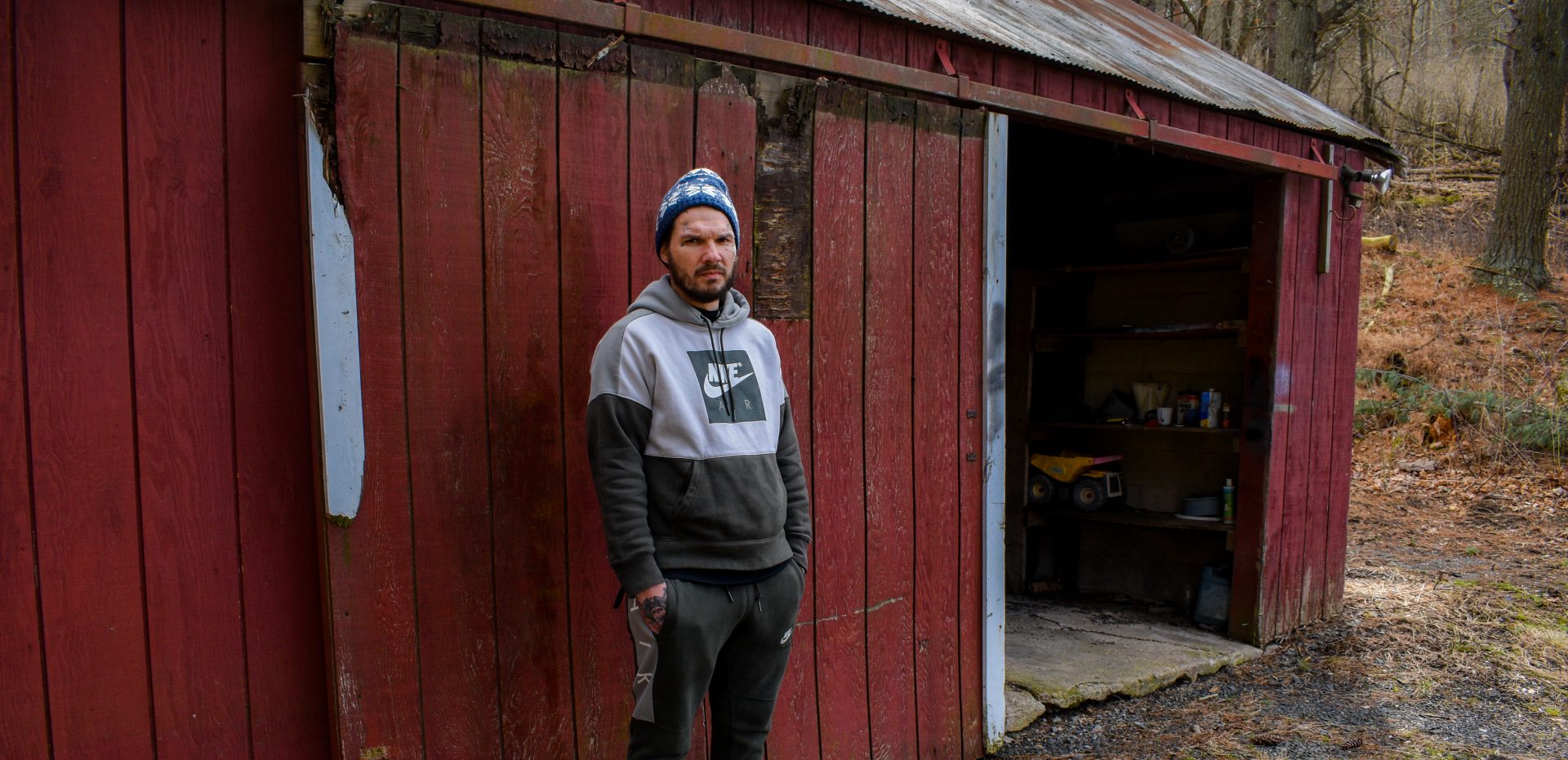 Jordan Bugg stands outside a shed at his mothers home, where he lives, in Catawissa, Pennsylvania. Jordan suffered from a tooth abscess in the Lebanon County jail, which he says was ignored by medical staff until he ended up on life support. 