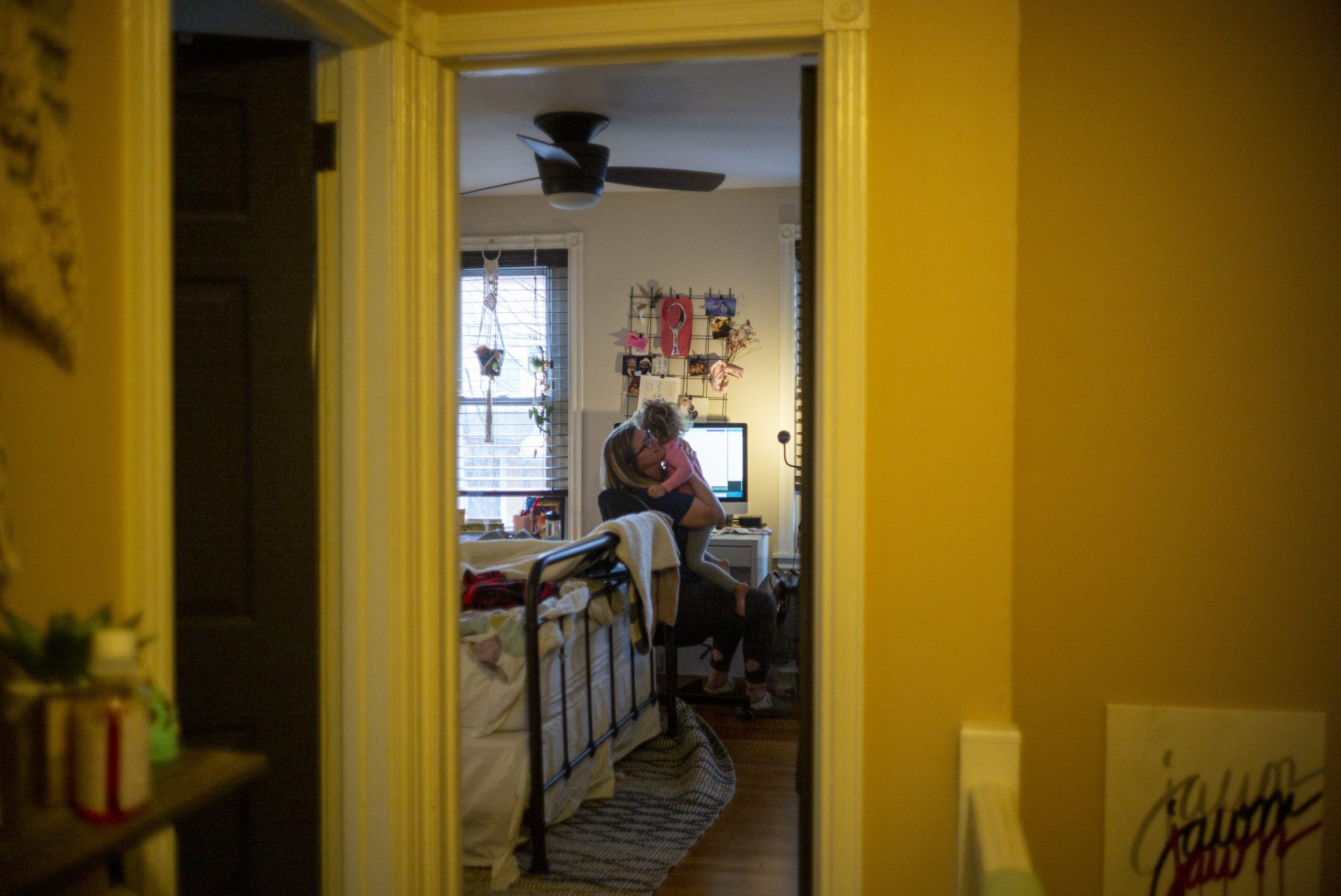 Art director Heather Marley works remotely from home while she is isolated at her Roxborough home. Her daughter Charleigh is seen here visiting her at her desk.