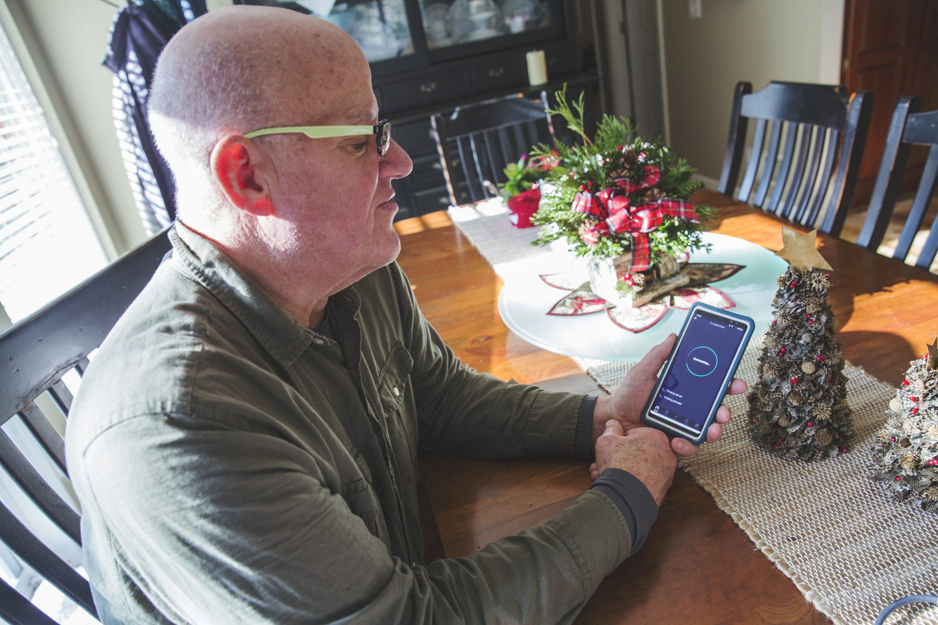 Tom Bracken, a volunteer at the cooperative, tests the DSL internet speeds at home.