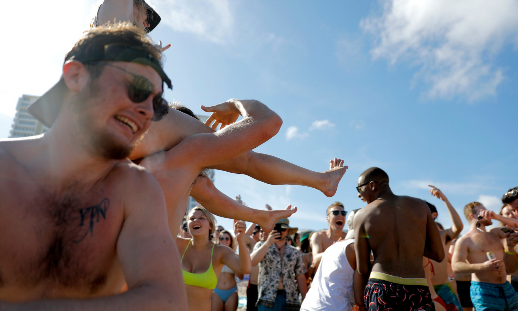 Spring break revelers party on the beach, Tuesday, March 17, 2020, in Pompano Beach, Fla. (Julio Cortez/AP Photo)