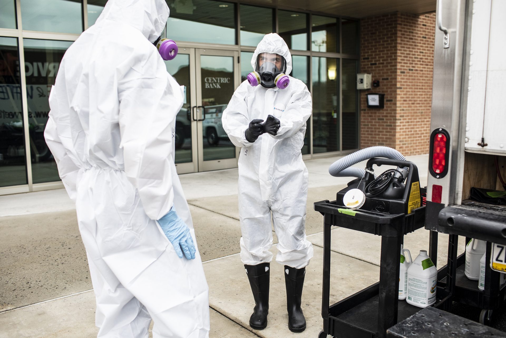 Service 1st Restoration worker Adam Copenhaver prepares to spray disinfectant throughout the Centric Bank corporate headquarters to stop the spread of the coronavirus.