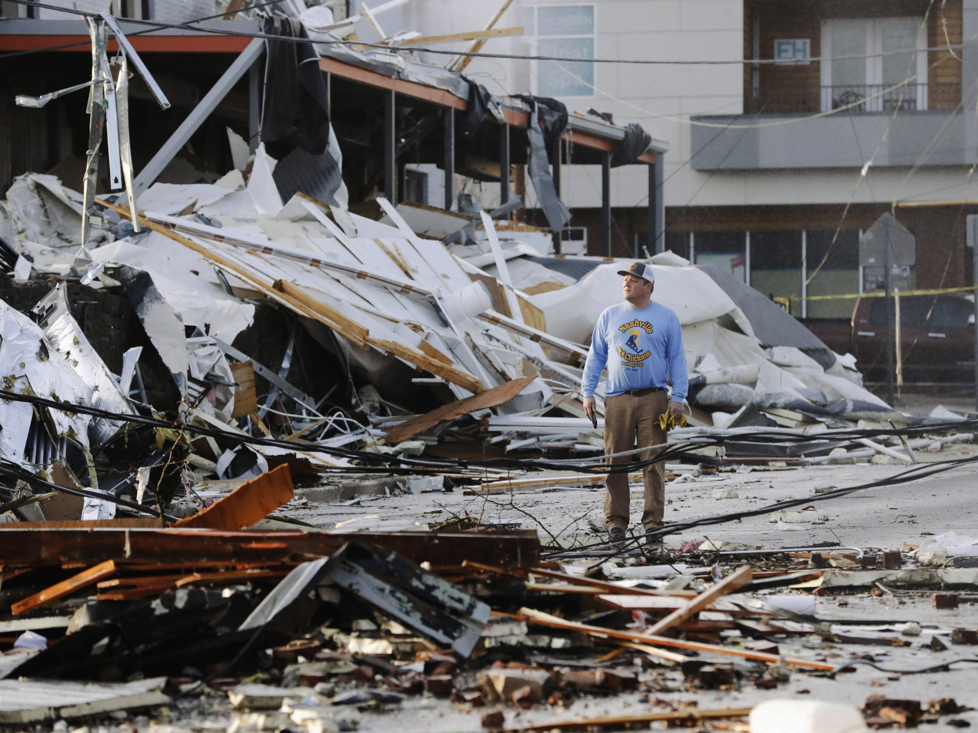 A man looks over buildings destroyed by storms on Tuesday in Nashville, Tenn. Tornadoes ripped across Tennessee early Tuesday, shredding buildings and killing multiple people.