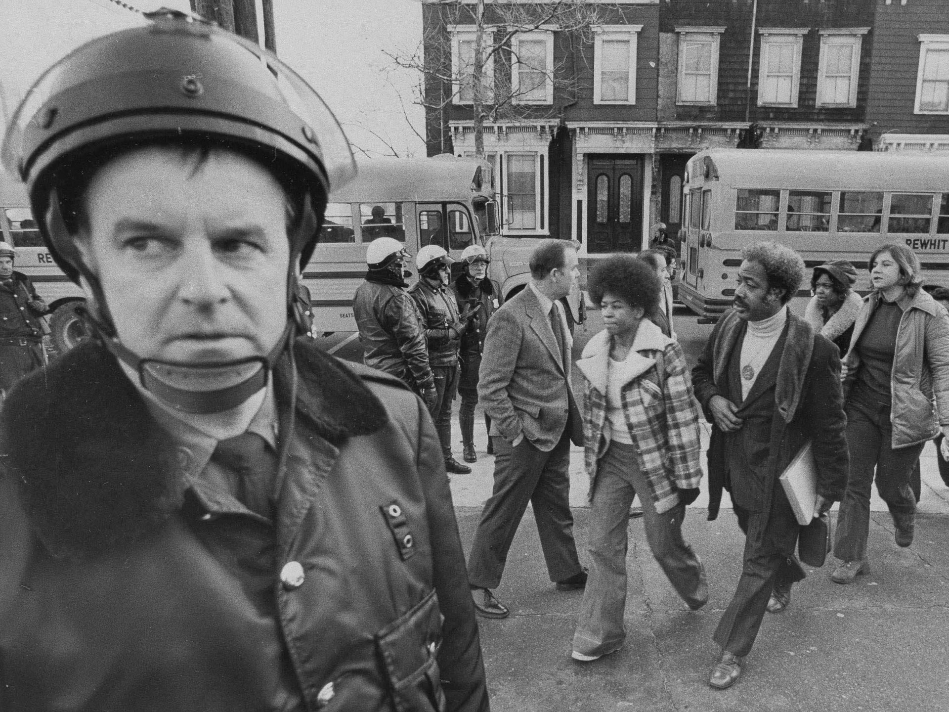 Buses arrive at South Boston High School, Jan. 8, 1975 as classes resume at the racially troubled institution. Police were on hand to provide protection as black students arrived.
