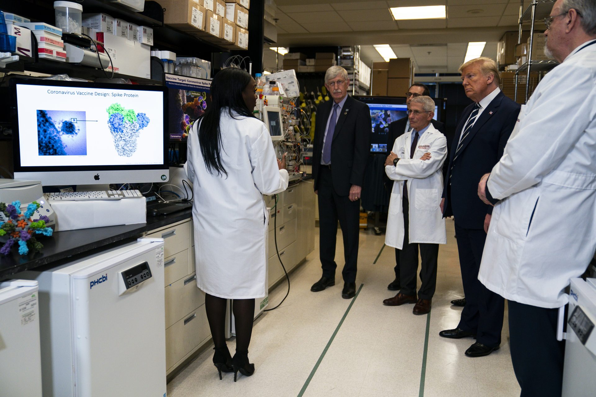 Dr. Kizzmekia Corbett, Senior Research Fellow and Scientific Lead for Coronavirus Vaccines and Immunopathogenesis Team in the Viral Pathogenesis Laboratory, left, talks with President Donald Trump as he tours the Viral Pathogenesis Laboratory at the National Institutes of Health, Tuesday, March 3, 2020, in Bethesda, Md.