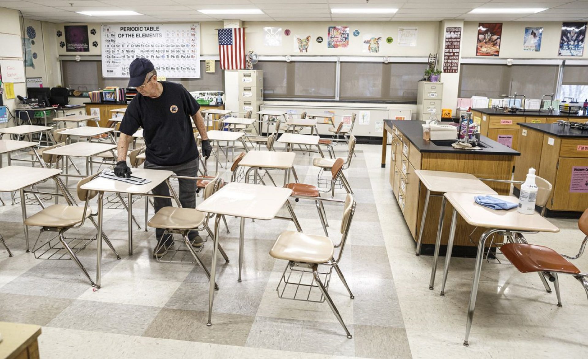 Custodian Luis Perez uses a cleaning solution applied to a cloth to wipe down all high-touch areas in a chemistry classroom. Custodial staff at East Pennsboro High School sanitize surfaces each day as a precautionary measure for the coronavirus, known as COVID-19, March 11, 2020.