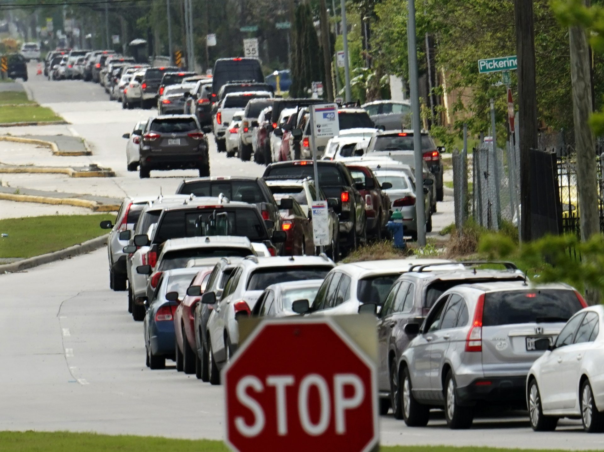 A line of cars stretches over two miles as people wait to enter a drive-thru testing site for COVID-19 at United Memorial Medical Center Thursday, March 19, 2020, in Houston. For most people, the coronavirus causes only mild or moderate symptoms, such as fever and cough. For some, especially older adults and people with existing health problems, it can cause more severe illness, including pneumonia.
