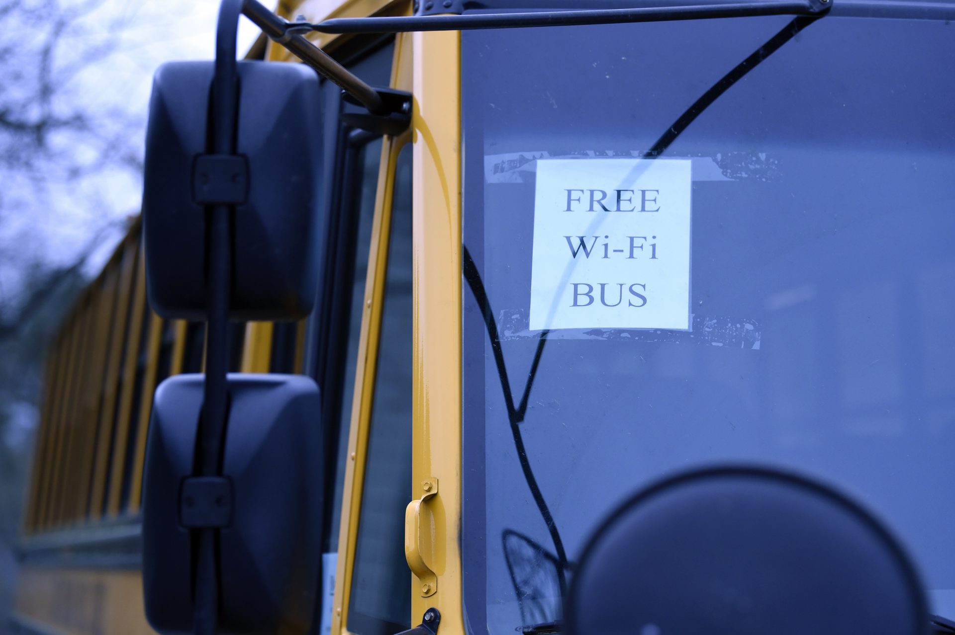 In this Thursday, March 26, 2020, photo, this wi-fi-enabled school bus, seen at an apartment complex in Winnsboro, S.C., is one of many being sent to rural and lower-income areas around South Carolina to help students with distance learning during the new coronavirus outbreak. With routers mounted inside, the buses broadcast enough bandwidth in an area the size of a small parking for parents to drive up and children to access the internet from inside their cars.