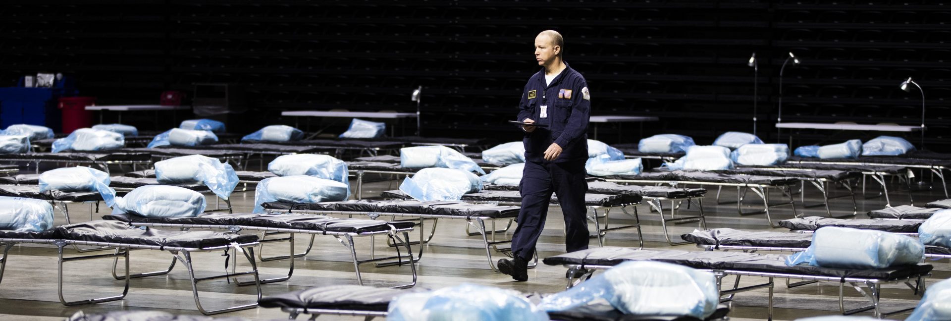 Pennsylvania Task Force 1 member Greg Rogalski walks amongst the beds of a Federal Medical Station for hospital surge capacity set up at Temple University's Liacouras Center in Philadelphia, Monday, March 30, 2020.