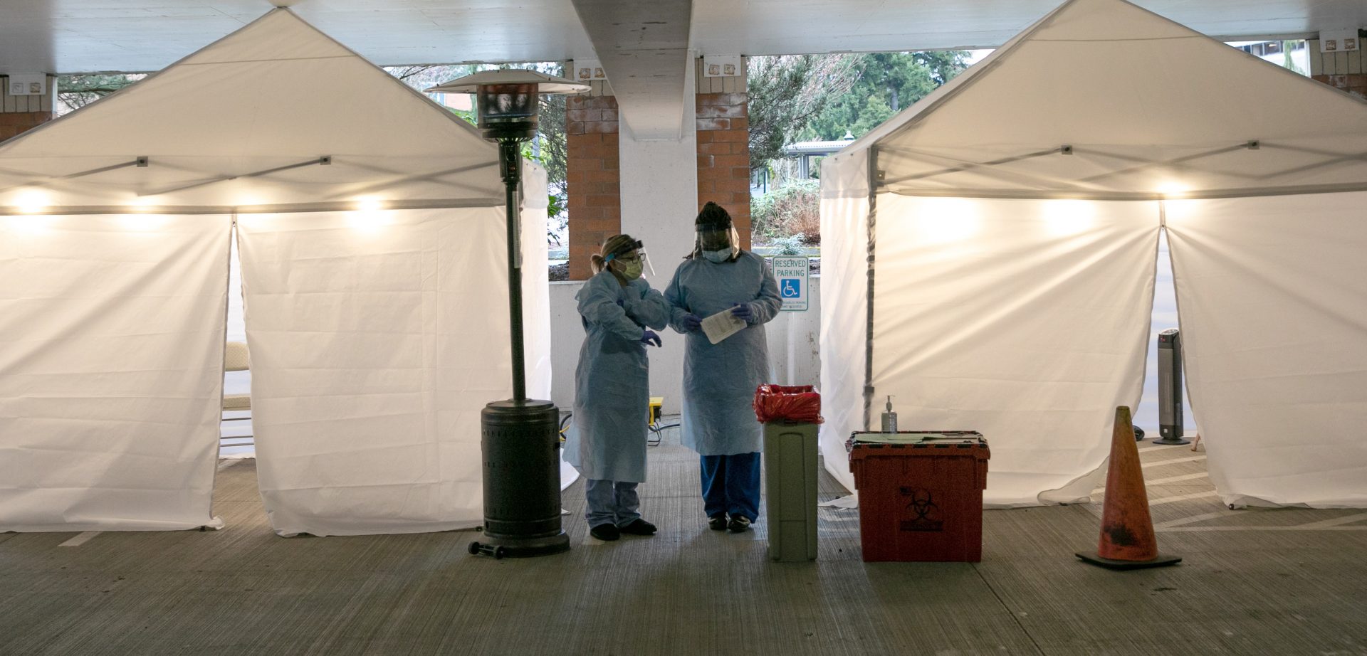 Nurses check registration lists before testing patients for coronavirus at the University of Washington Medical Center on March 13 in Seattle.