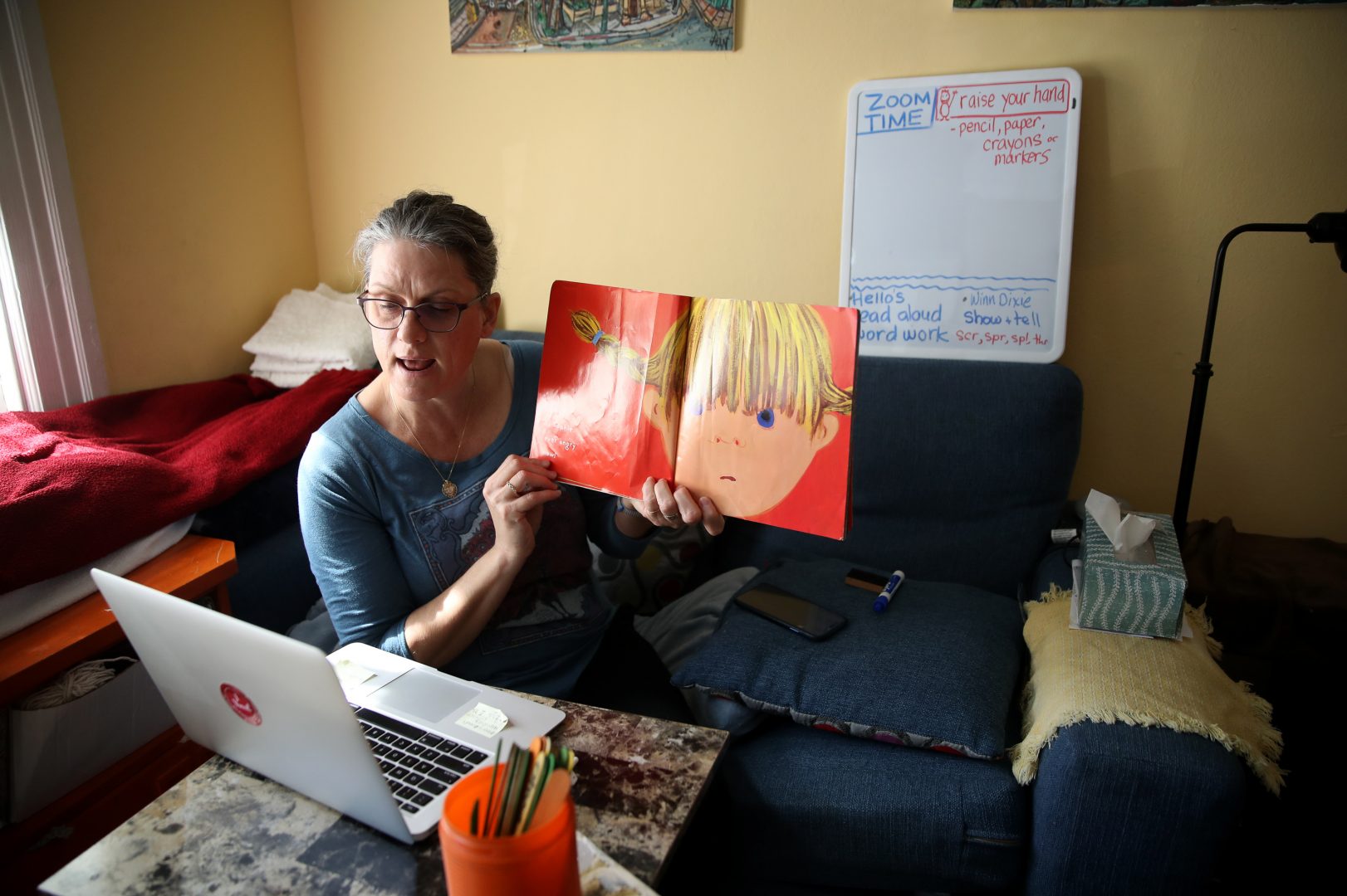Leanne Francis, first grade teacher at Harvey Milk Civil Rights Academy, conducts an online class from her living room on March 20, 2020 in San Francisco, Calif. With schools closed across the U.S., teachers are holding some classes online.