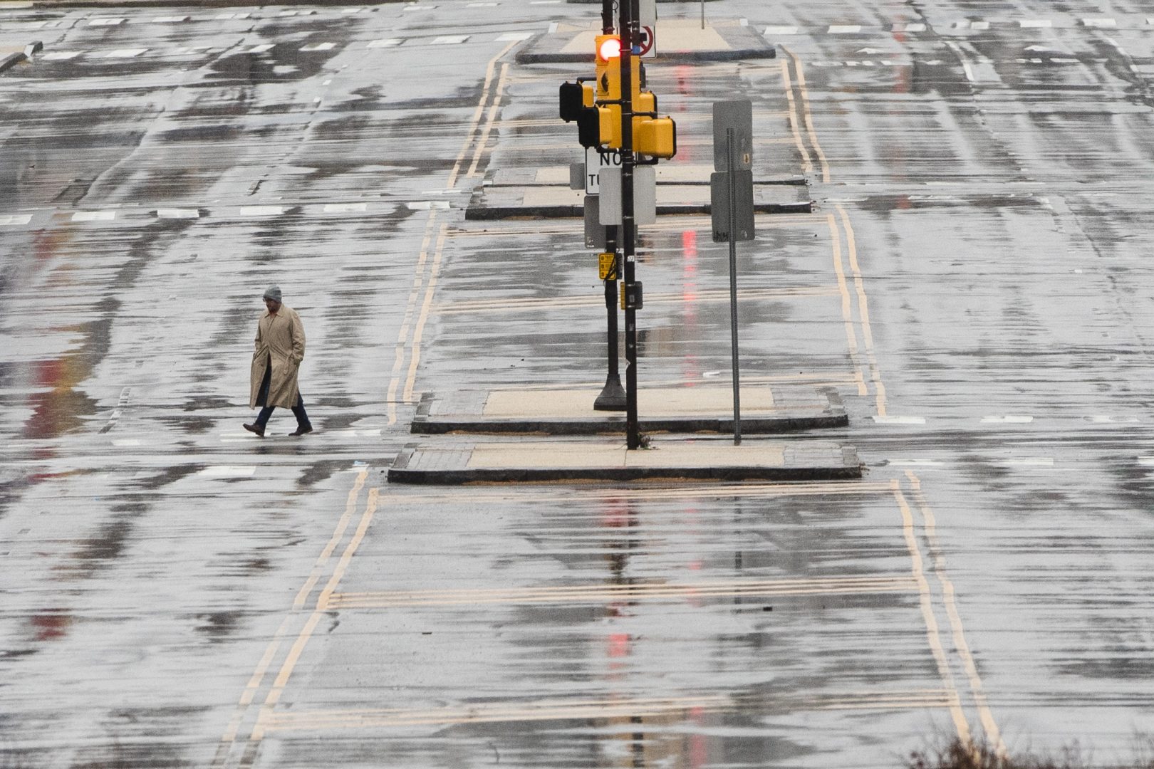 A person crosses the Benjamin Franklin Parkway in Philadelphia, Monday, March 23, 2020. Philadelphia Mayor Jim Kenney is issuing a stay-at-home order to the nation's sixth most-populated city to keep its 1.6 million people from leaving home, except to get food, seek medical attention, exercise outdoors, go to a job classified as essential or other errands that involve personal and public safety.