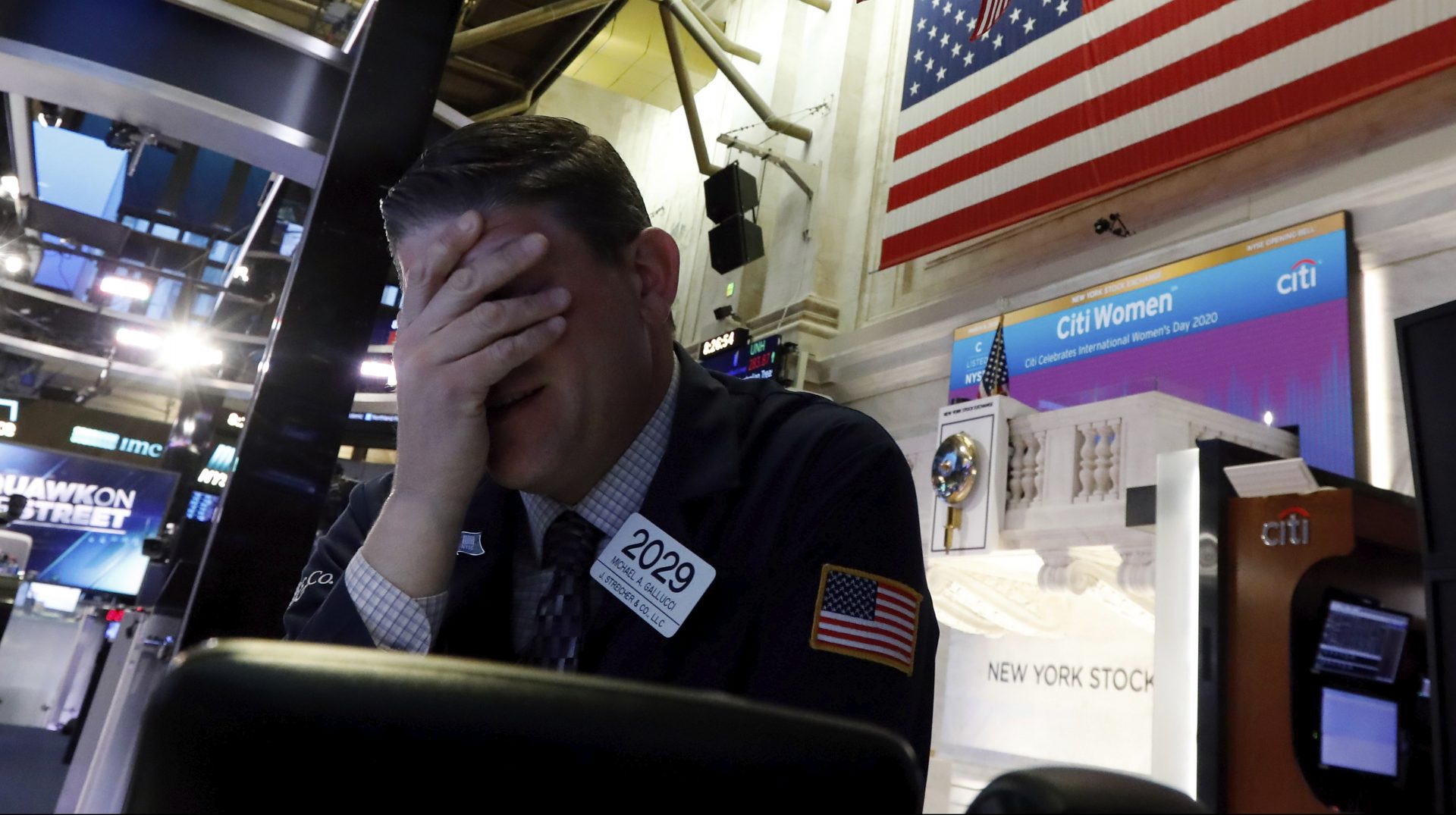 Trader Michael Gallucci prepares for the day's activity on the floor of the New York Stock Exchange, Monday, March 9, 2020. Trading in Wall Street futures has been halted after they fell by more than the daily limit of 5%.