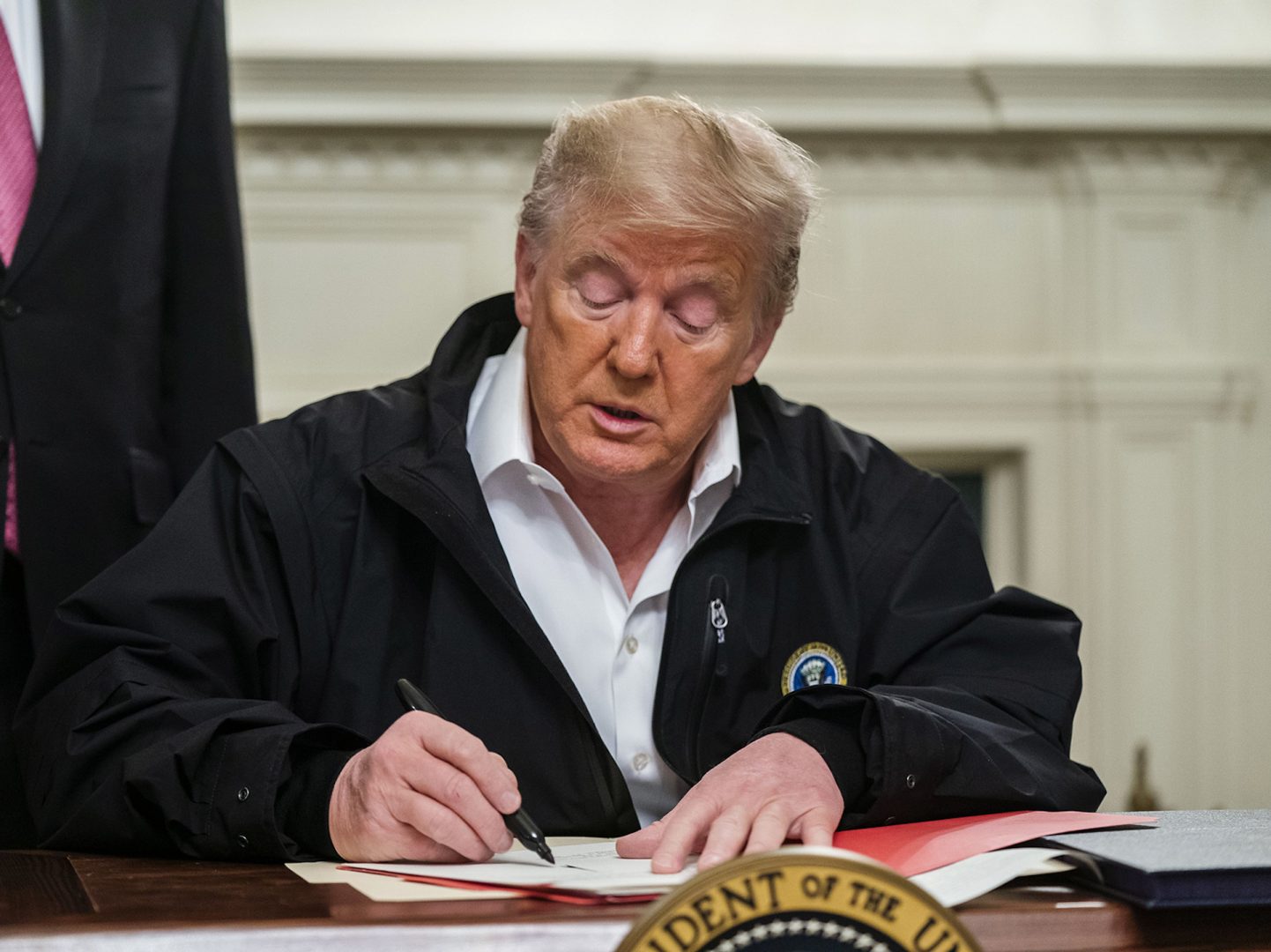 President Trump signs an $8.3 billion emergency spending bill in the White House Friday. That's significantly more than he originally requested from Congress.