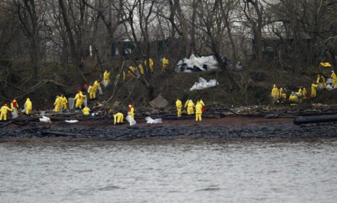 Work crews clean oil off the banks of the Delaware River in National Park, N.J., Monday, Dec. 6, 2004. The Athos I spilled as much as 470,000 gallons of thick crude oil into the Delaware River, killing wildlife and spreading along 70 miles of the waterway. 