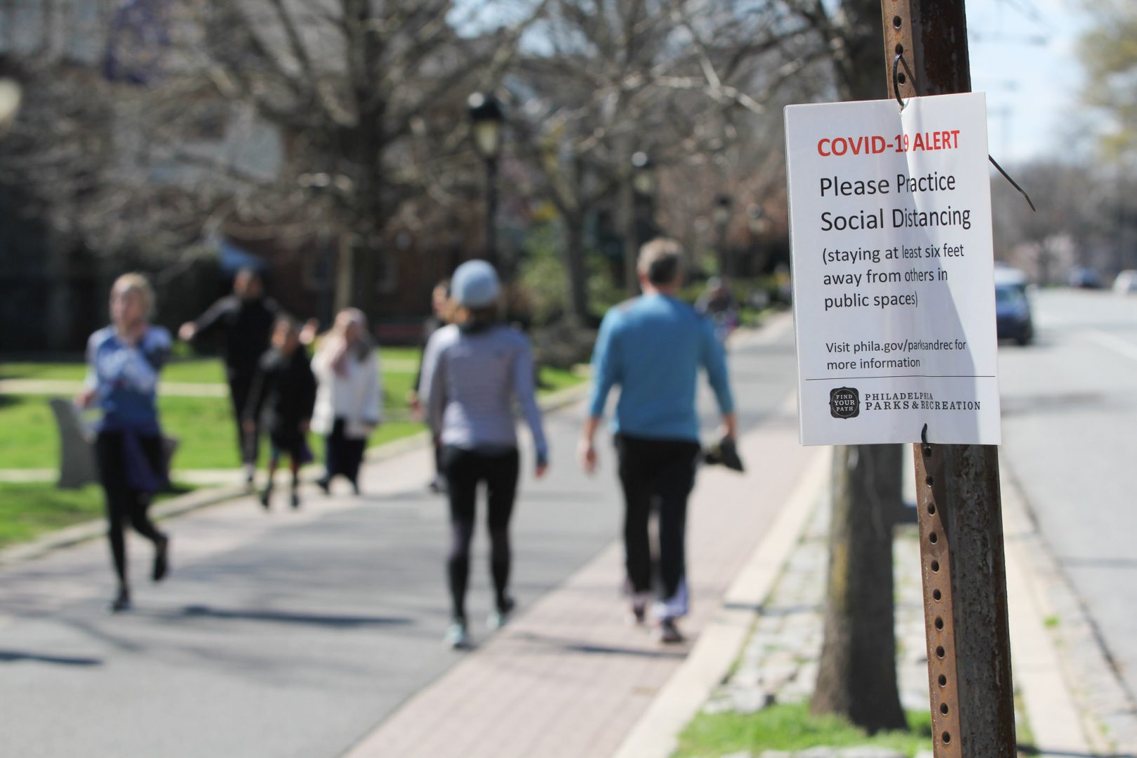 Signs posted along Philadelphia's Schuylkill River Trail caution users to keep six feet away from others to prevent the spread of COVID-19. 