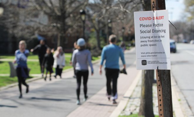 Signs posted along Philadelphia's Schuylkill River Trail caution users to keep six feet away from others to prevent the spread of COVID-19. 