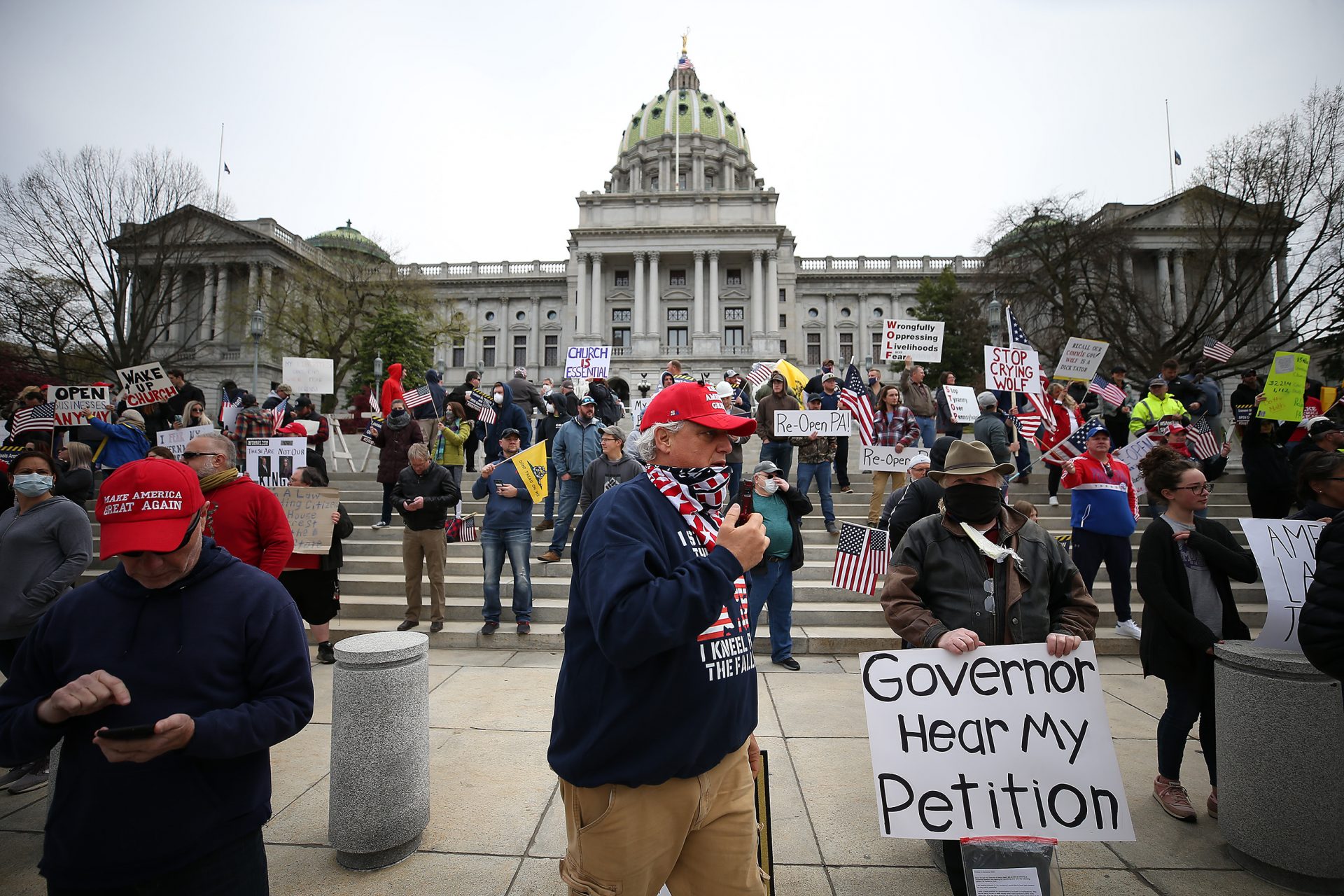 Protesters gather outside the Capitol Complex, calling on Gov. Tom Wolf to reopen up the state's economy during the coronavirus outbreak.