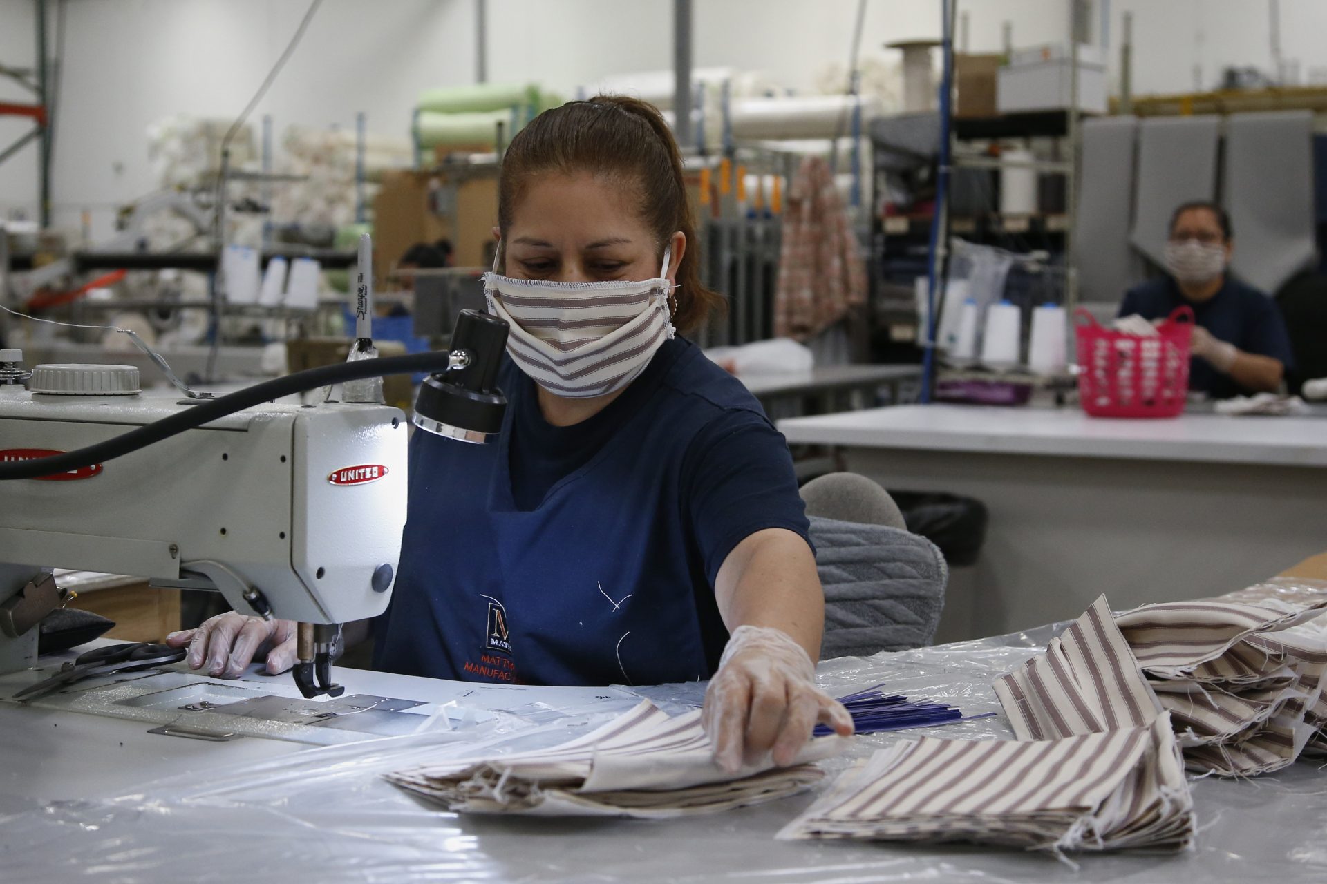 Workers at the Mathis Brothers mattress factory sew face masks Wednesday, April 1, 2020, in Oklahoma City. The masks, which are being supplied to the University of Oklahoma Medical Center and Norman Regional Hospital, are approved for use for visitors, non-COVID-19 patients, and to be worn by health-care professionals over their N95 masks for additional protection. The new coronavirus causes mild or moderate symptoms for most people, but for some, especially older adults and people with existing health problems, it can cause more severe illness or death.