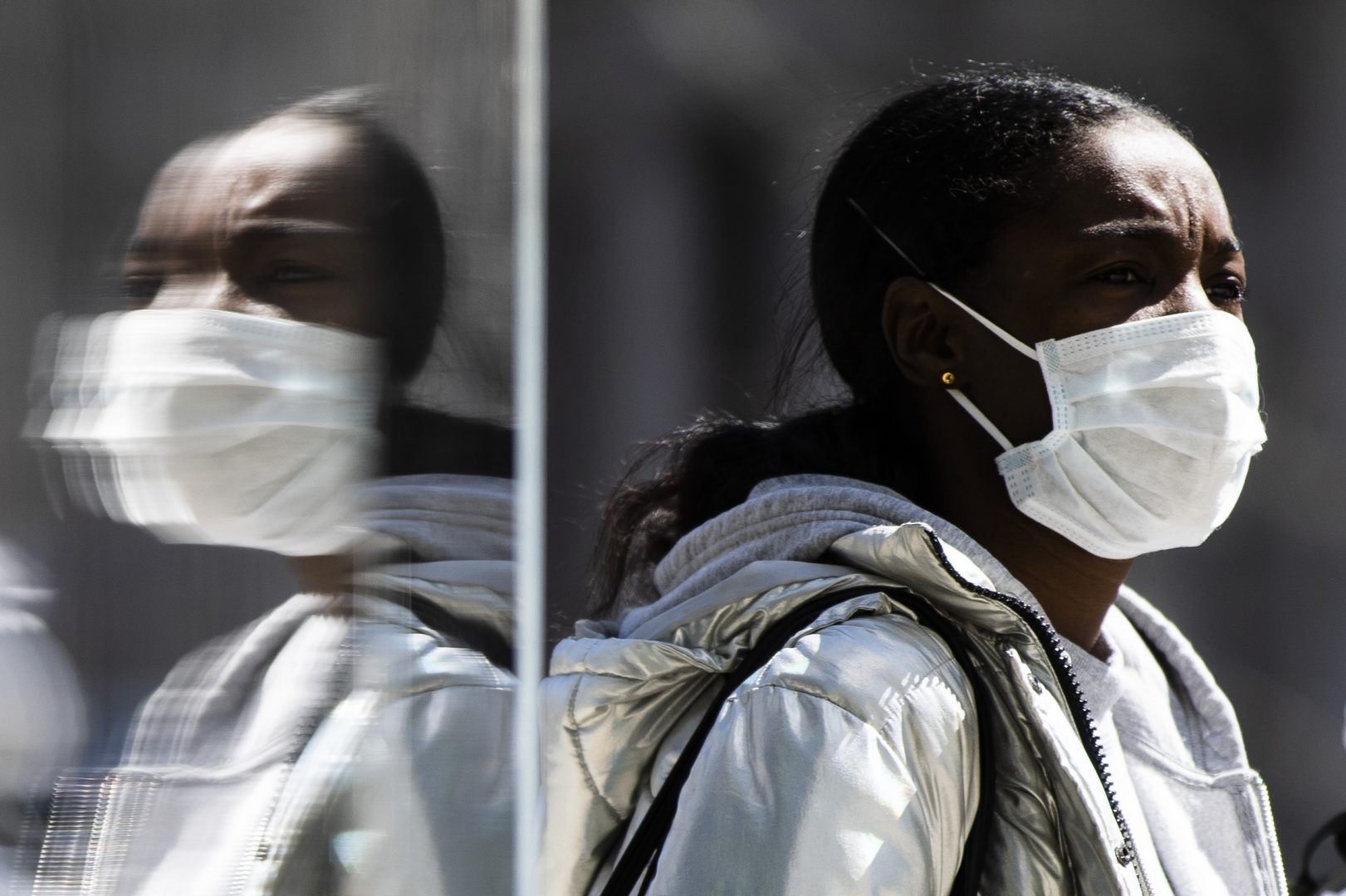 A person wearing protective masks due to coronavirus concerns walks in Philadelphia, Thursday, April 2, 2020.