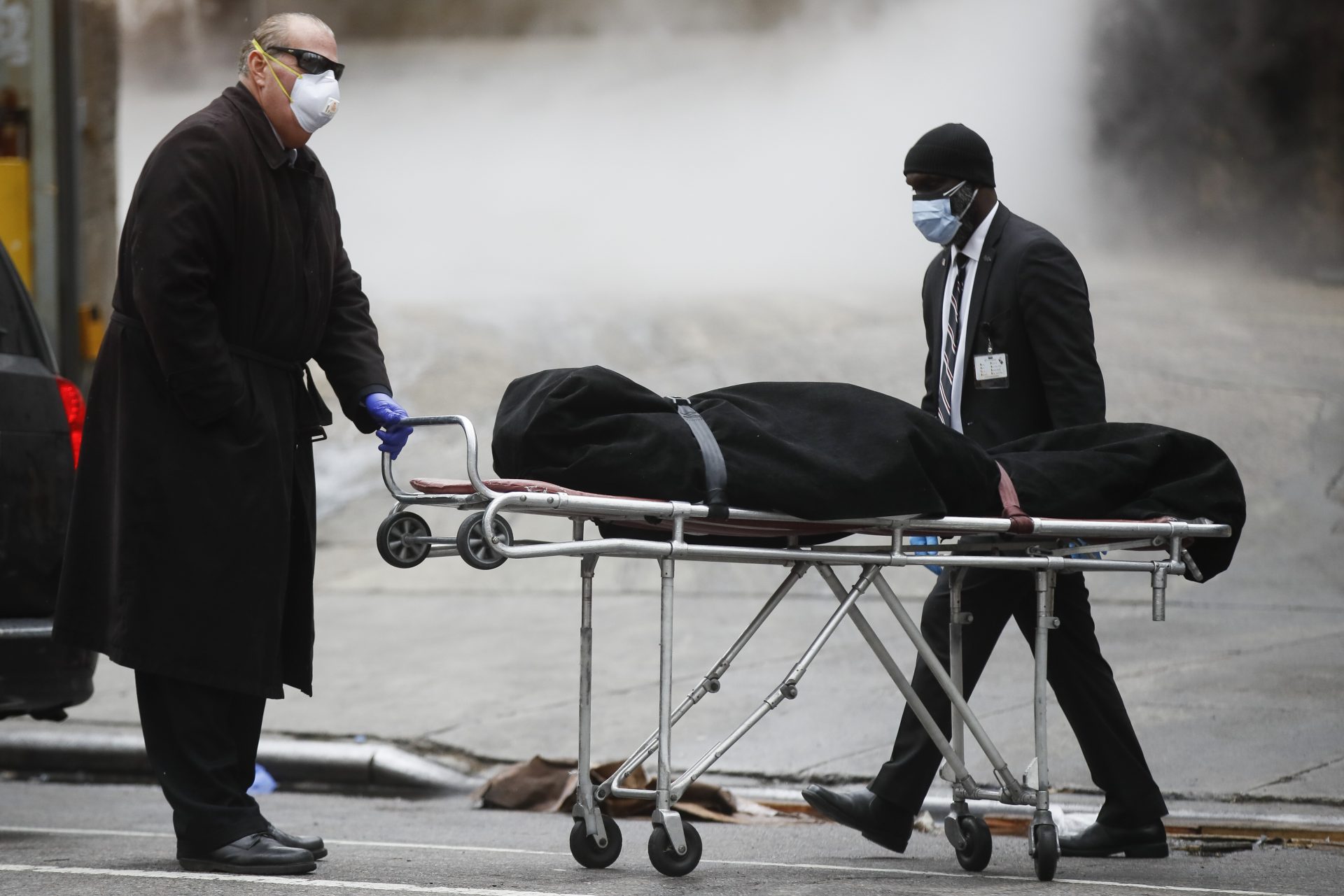 A funeral director wears personal protective equipment due to COVID-19 concerns while collecting a body at The Brooklyn Hospital Center, Thursday, April 9, 2020, in the Brooklyn borough of New York.