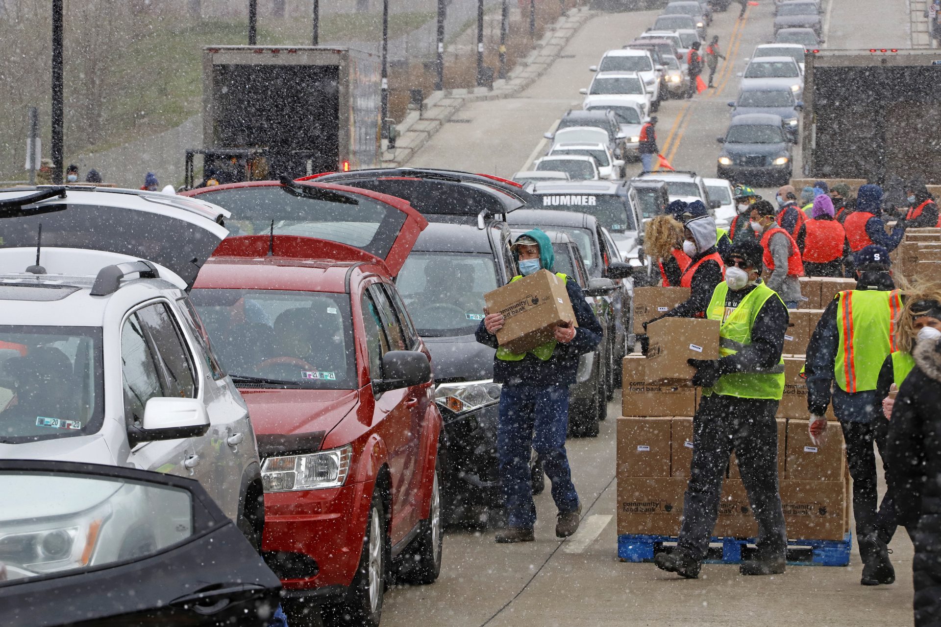 Boxes of food are distributed by the Greater Pittsburgh Community Food Bank, at a drive thru distribution near PPG Arena in downtown Pittsburgh, Friday, April 10, 2020.