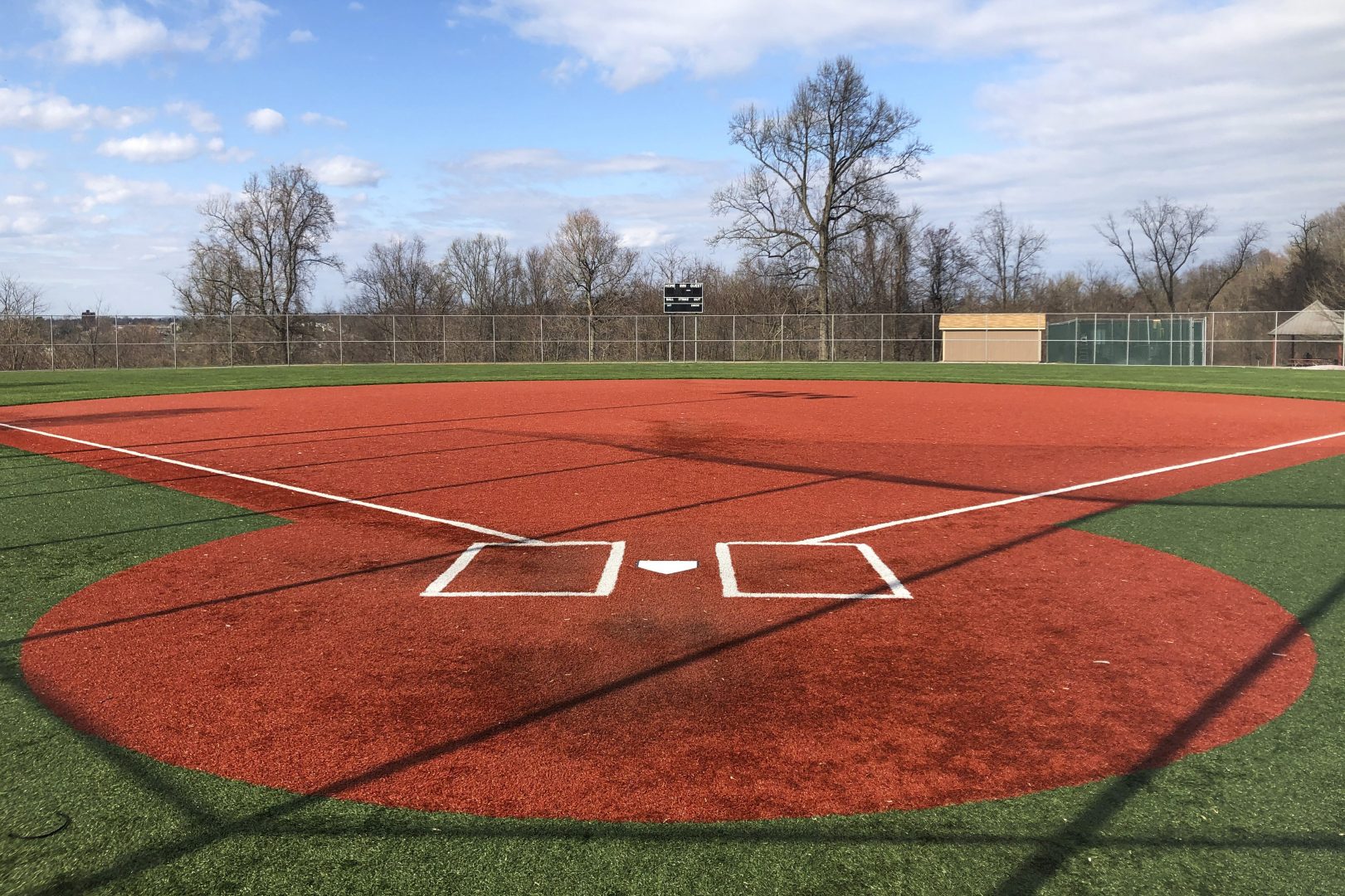 In this April 4, 2020, photo, a youth baseball field sits empty at Monroeville Park in Monroeville, Pa.